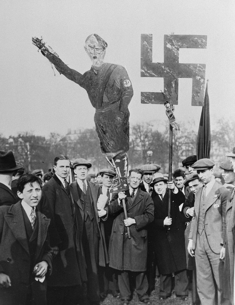 British Jews carry an effigy of Hitler and a large swastika at a mass demonstration in Hyde Park, where thousands are gathered to protest against the Nazi persecution of German Jews.