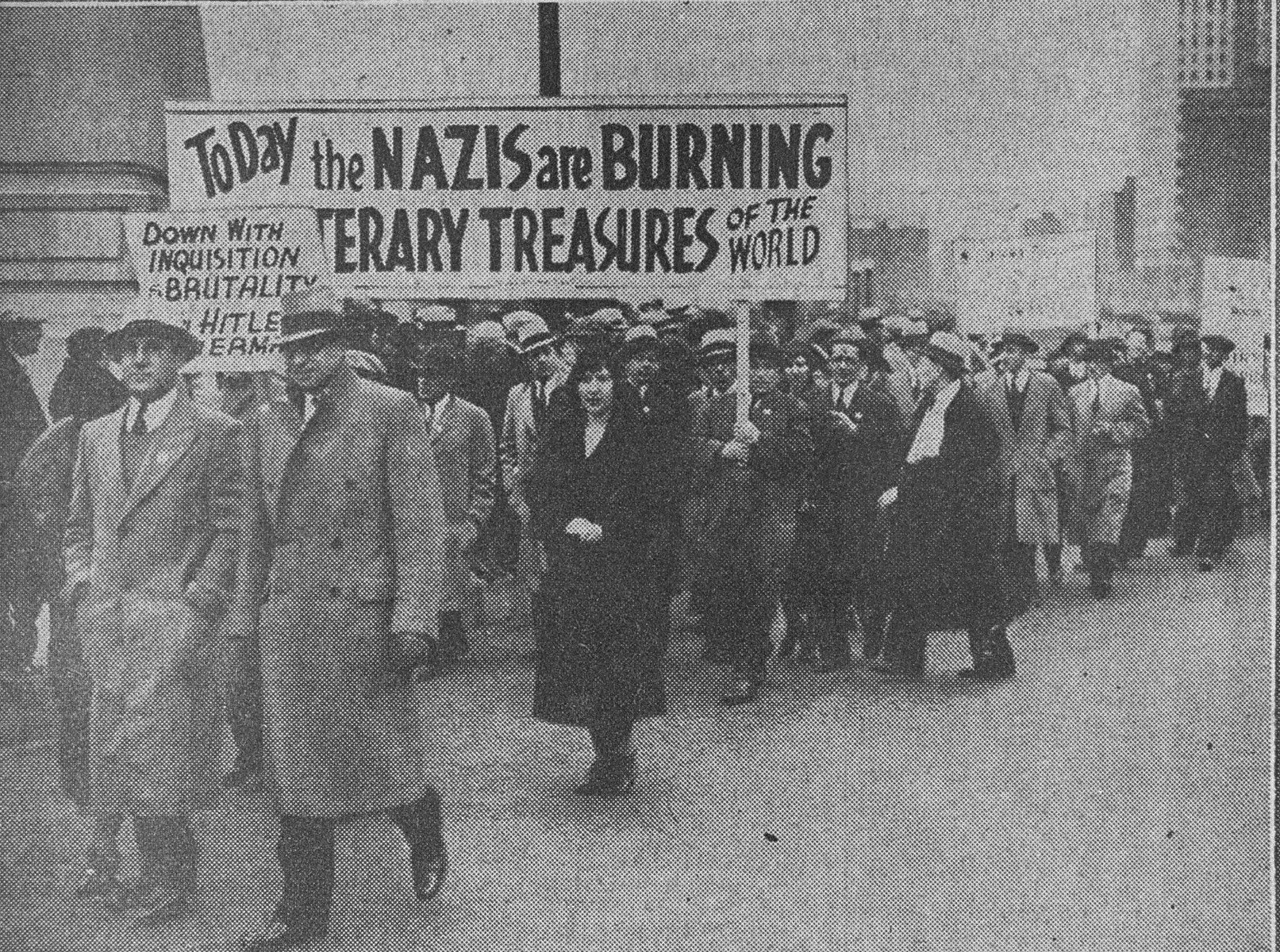 Jews march in Chicago to protest against the Nazi persecution of German Jews.  The marchers are following a route from Ashland Boulevard and Roosevelt Road to Grant Park, where they will hold a mass meeting.  

The original caption in the Chicago Herald Examiner reads, "Jews Protest Hitler Regime.  A general view of the parade of Chicago Jews who marched yesterday from Ashland Blvd. and Roosevelt Road to Grant Park at  Congress St., where they held a mass meeting of protest against the persecution of the Jewish race by the Hitler regime in Germany."