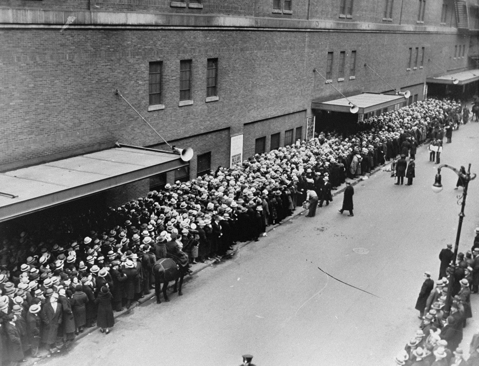 View of people queued up at the entrance to Madison Square Garden, where a mass demonstration is scheduled for later in the day to protest against the Nazi persecution of German Jews.  More than 20,000 people are expected to attend the event which will feature addresses by prominent Catholic, Protestant and Jewish speakers.