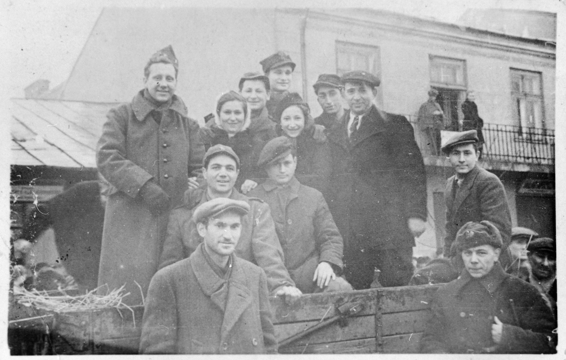 A group of newly liberated Jews pose with Soviet and American soldiers who were passing through the town of Losice.

The American soldiers had been taken captive after the Battle of the Bulge and were liberated by the Soviet army.  They were on their way back to the United States via Moscow.  After discovering that the soldiers were also Jewish, the Jews of Losice communicated with them in Yiddish.  

Among those pictured are Salus Mordkowicz, Asher Weinstein, Boris Mordkowicz, Belcia Pinkus, Ajzce Szerc, and Berl Losice.