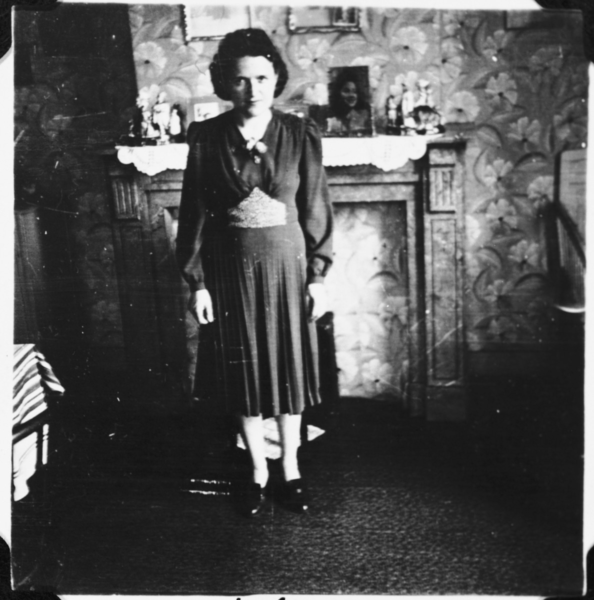 A Jewish woman who is living in hiding as a Christian, poses in the living room of her sister's apartment in Brussels, where her children were sheltered for many months during the German occupation.

Pictured is Fani Mendelowicz.