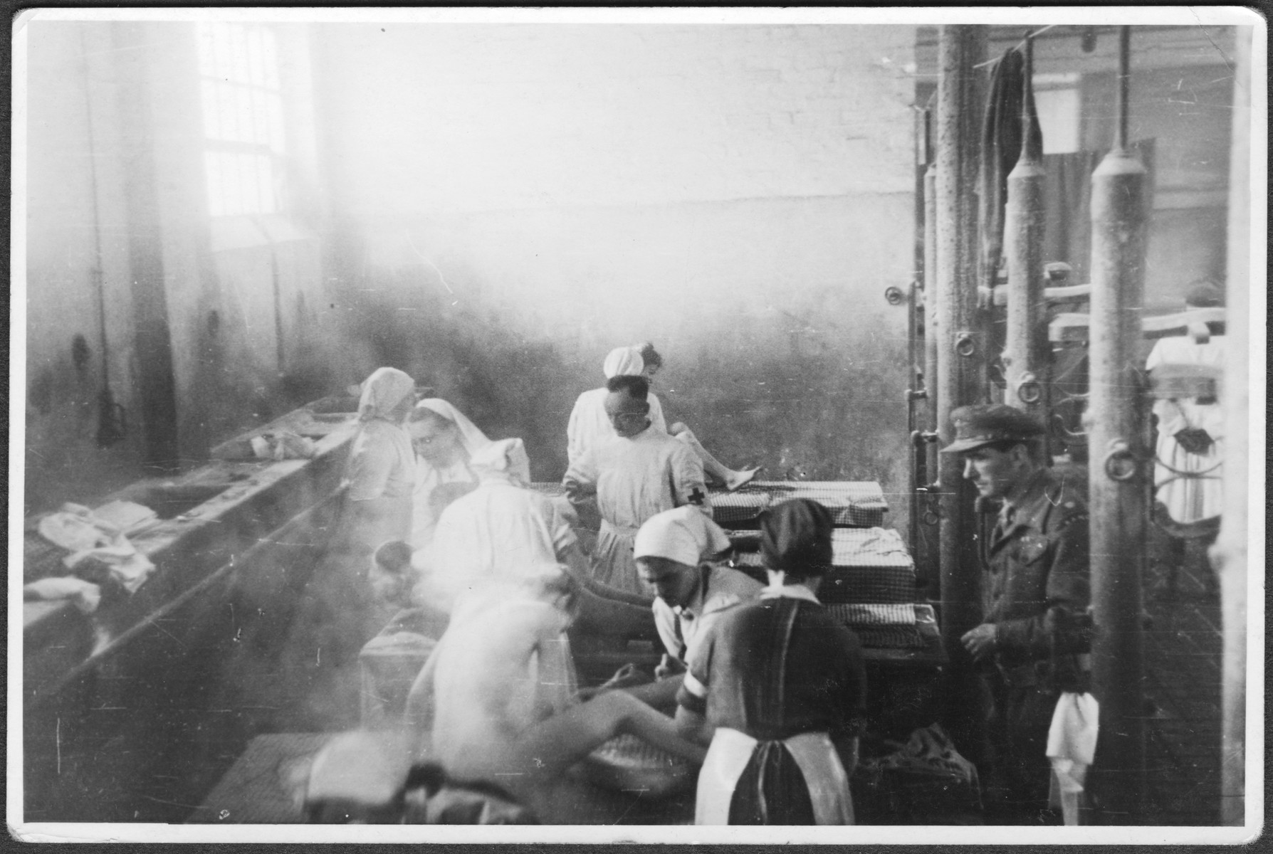 British medical personnel wash and disinfect survivors in Bergen-Belsen.