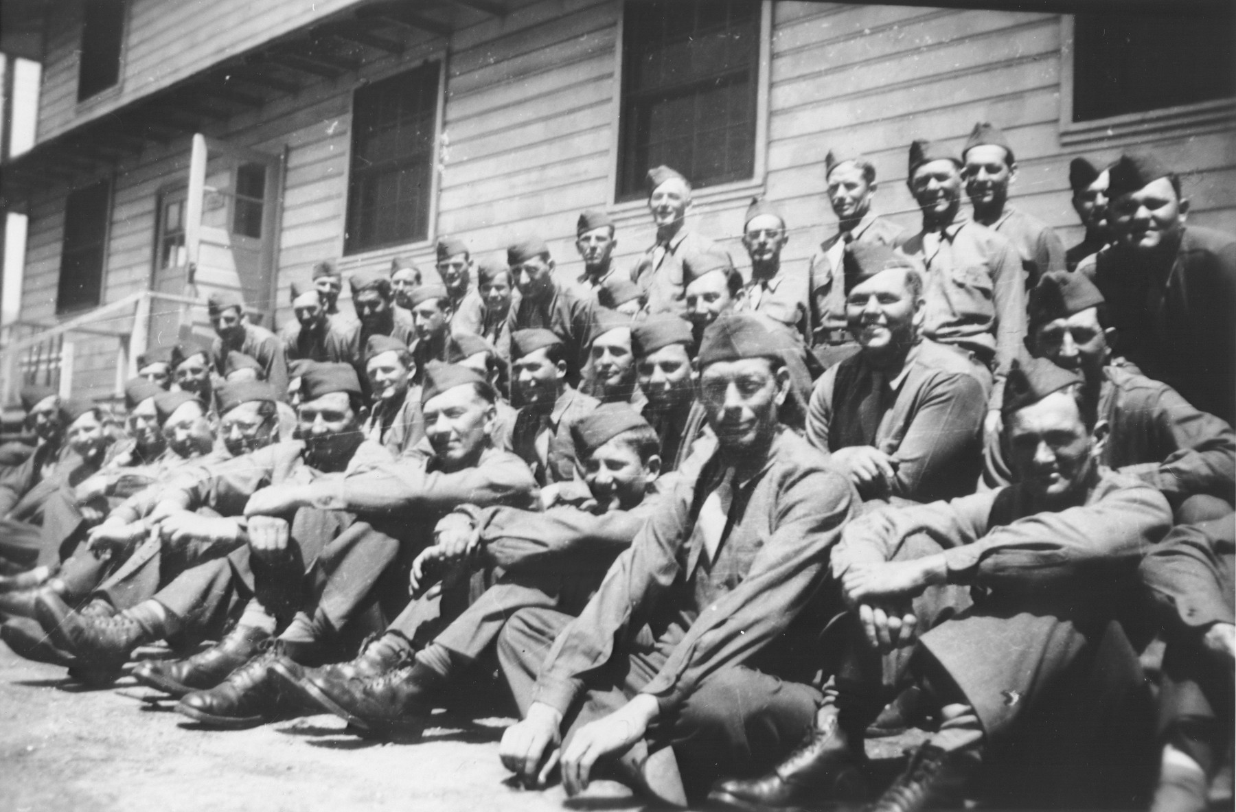 Otto Perl poses with his American army unit at Camp Ritchie, Maryland.

Willard Luther Richardson has been tentatively identified in the back row, far right.

Otto Perl was born in Vienna on September 22, 1915.  He was the son of Martha Knopfmacher and Leopold Perl, a Viennese businessman.  Otto had one brother, Kurt (b. 1917).  During the year preceeding the Anschluss, Otto was serving in the Austrian Army.  After his dismissal in March 1938 for being a Jew, Otto was arrested by the Gestapo and sent to Dachau.  On September 22 he was transferred to Buchenwald, where he remained until his release on March 15, 1939.  He then returned to Vienna.  With the help of a friend who had emigrated to the US in 1933, Otto was able to get an American visa.  He left Austria in June 1939 but was waylaid for nine months in a refugee camp in Ramsgate, England, before reaching New York in March 1940.  Otto's mother committed suicide in 1941 or 1942.  His father was arrested in Vienna in 1942 and died of a heart attack while on his way to the deportation trains.  Otto's younger brother escaped to Italy and from there made his way to Columbia.  Later, he was able to join Otto in the United States.