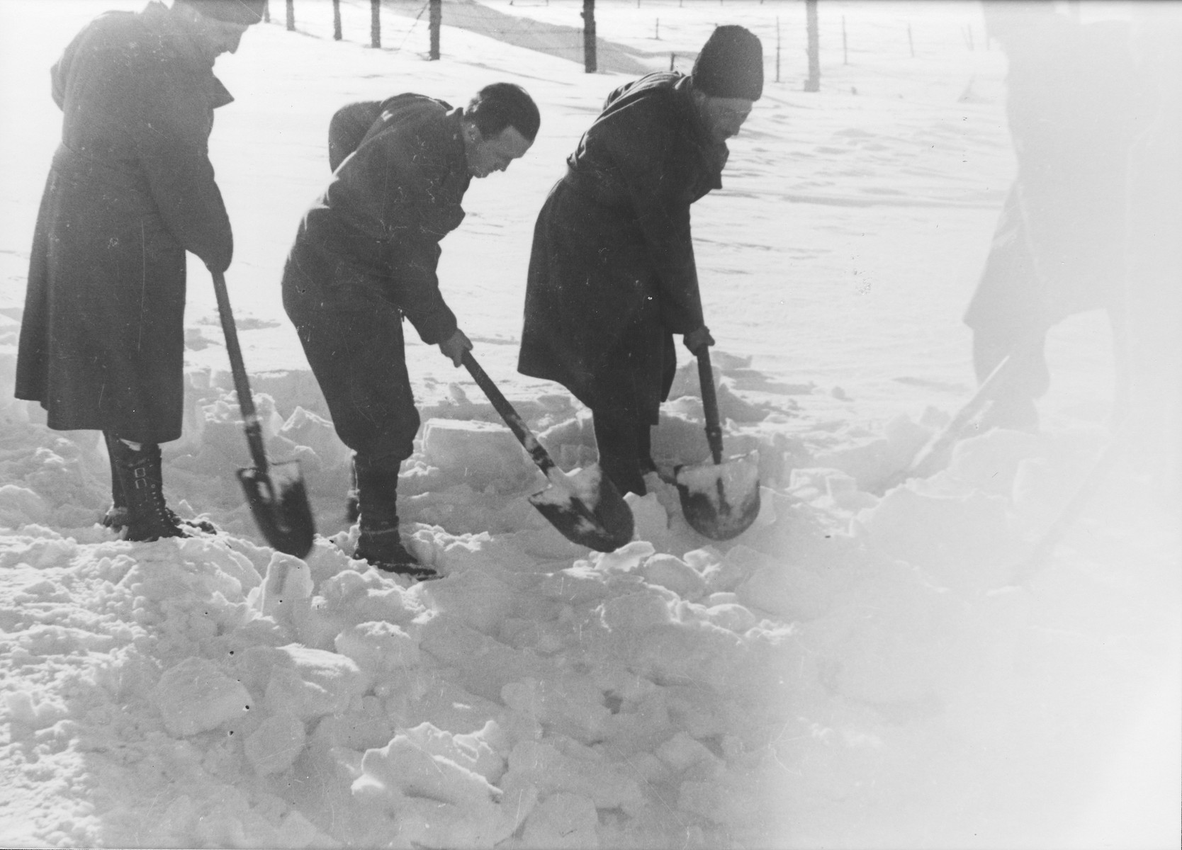 Jewish conscripts in Company 108/57 of the Hungarian Labor Service at forced labor clearing snow from a road.