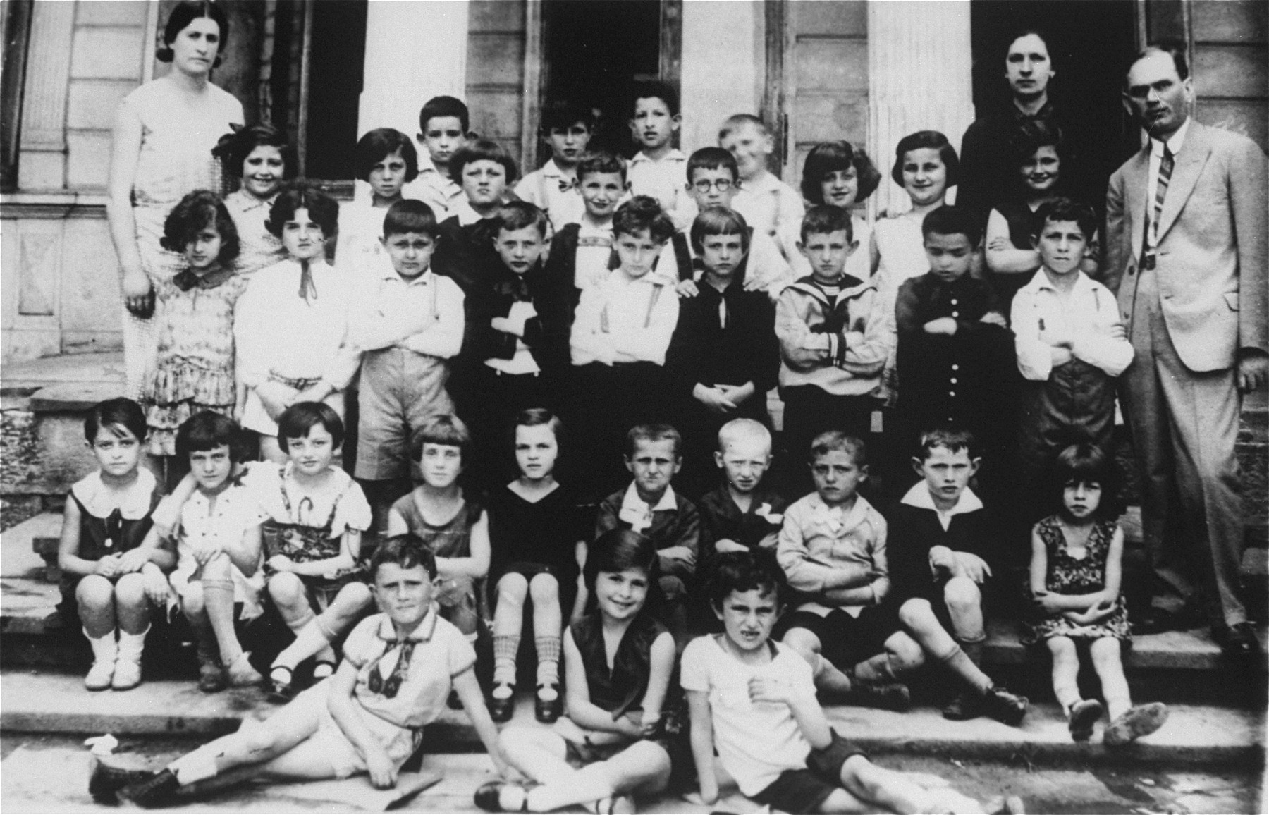 Class portrait of children at a Jewish primary school in Stanislawow.

Amalie Petranker is pictured in the third row from the front, fourth from the right.