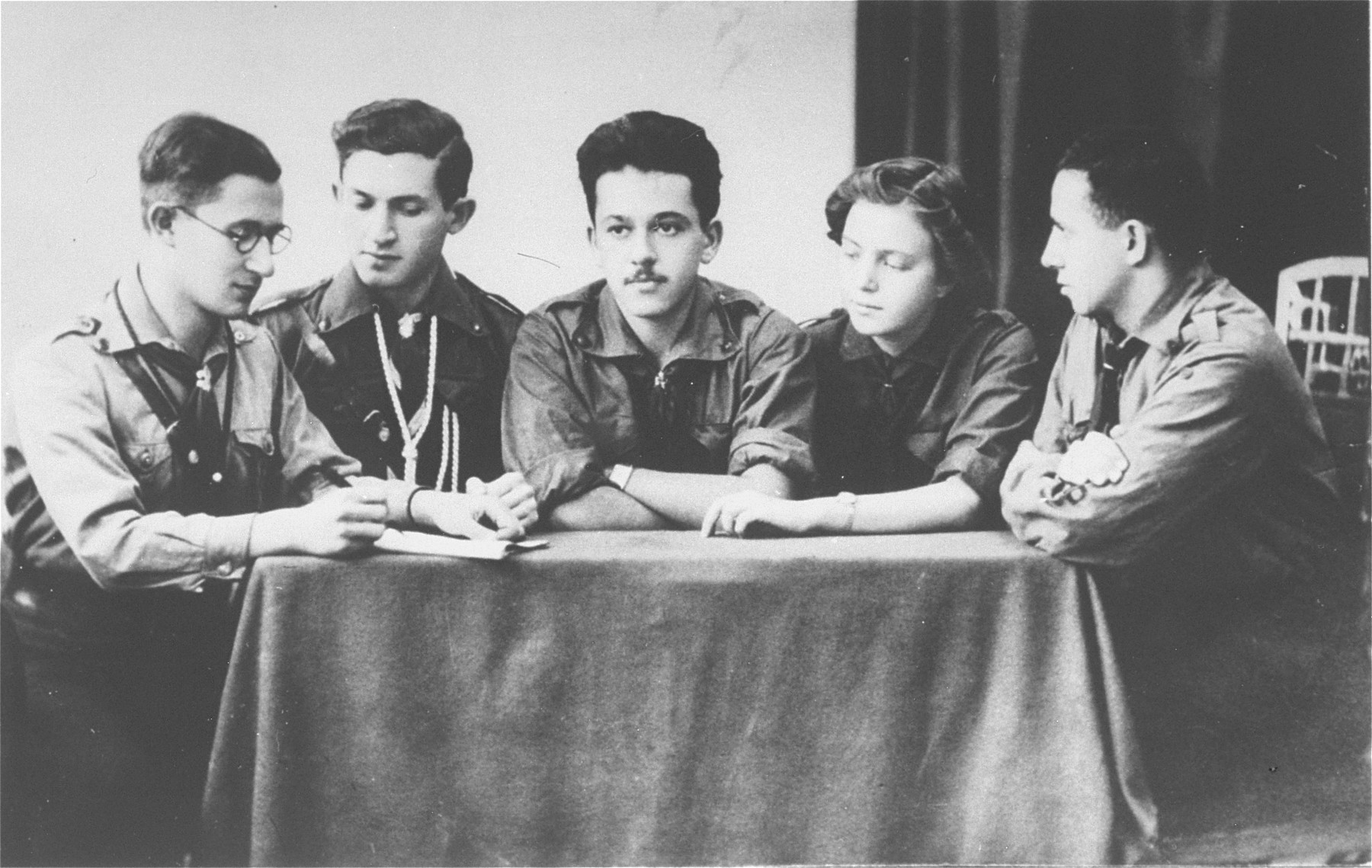 Group portrait of members of the Hanoar Hatzioni Zionist youth movement in Sosnowiec.

All were active in the Zionist underground in Sosnowiec during the German occupation.  Pictured from left to right are, Dr. Bursztyn, Josef Kozhuch, Samek Meitlis, Lola Pomeranzblum, and Benjamin Bimko (the donor's brother).  Samek and Lola were married.  All but Dr. Bursztyn were shot by the Germans during the final liquidation of the ghetto in August 1943.