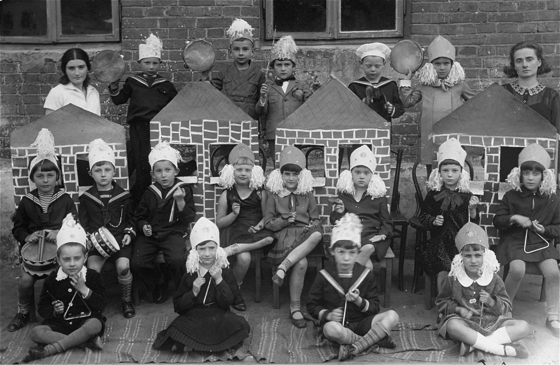 Kindergarten children at the Reali Hebrew gymnasium in Kovno perform in a school play.

Among those pictured is Hana Trozki (front row, right).