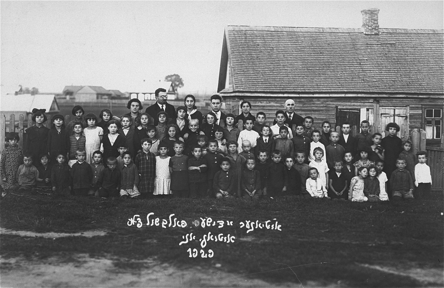 Group portrait of the students and teachers of the Jewish Volksschule (elementary school) in Utena.


Pictured in the back row, center, is Joseph Gar.