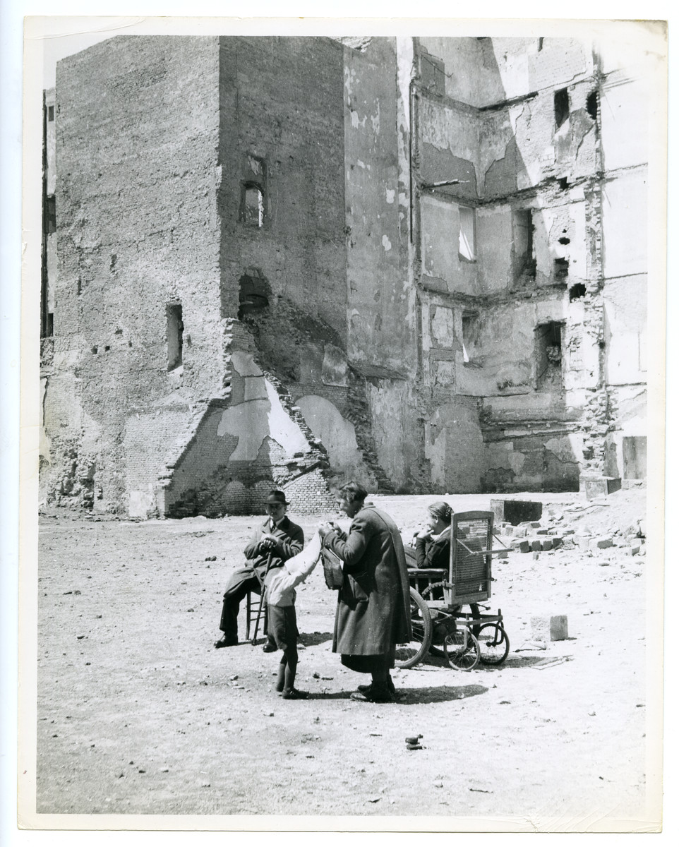 A family relaxes in the sun amid war ruins in bombed-out Vienna,.

The photo's original caption reads: "The Place in the Sun."