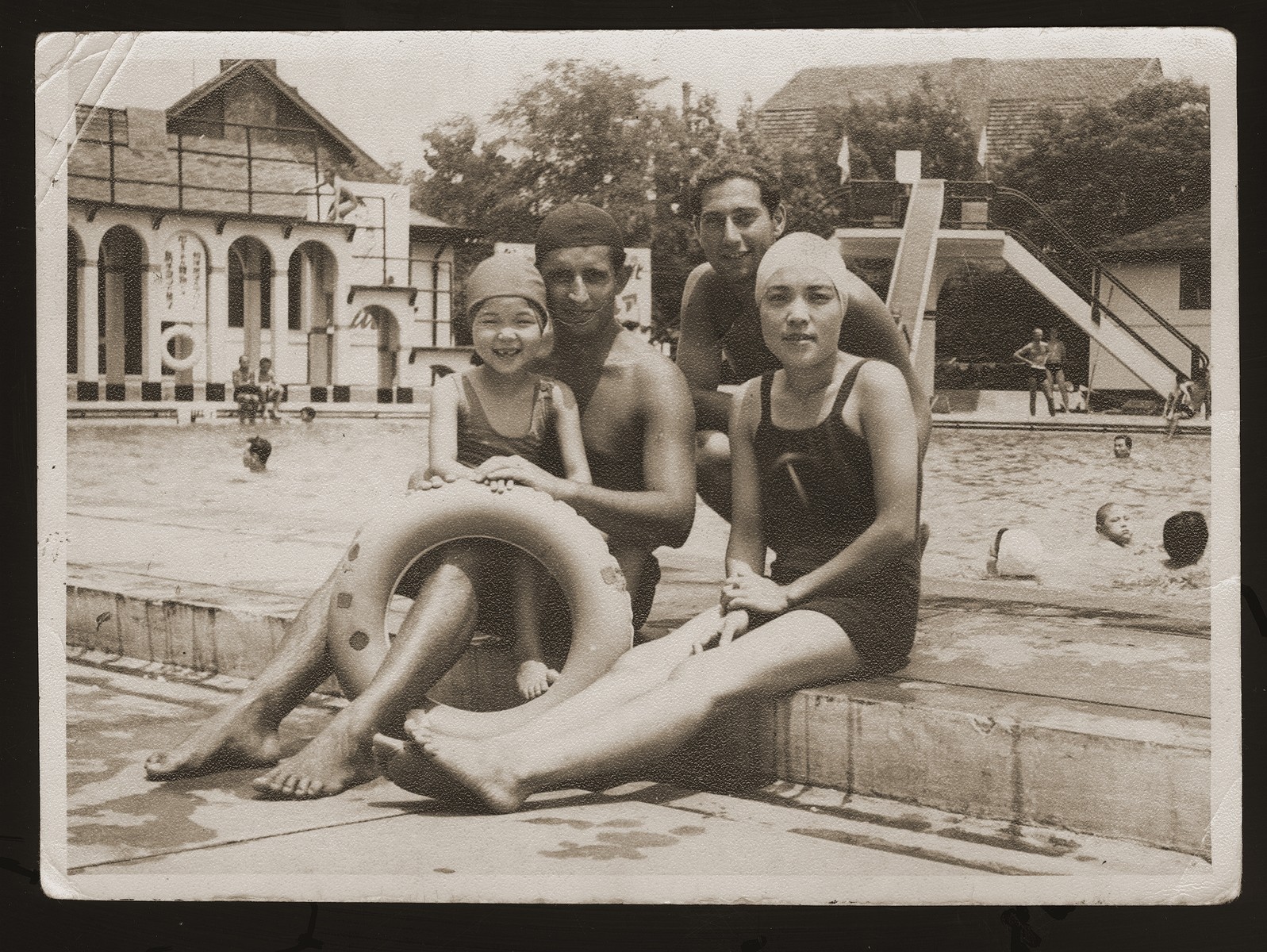 Peter Victor (second from right), a Jewish refugee from Berlin, with his friends Ely, Mrs. Oda, and her daughter at the Hongkew Park swimming pool.  

Hongkew Park was a Japanese country club where Victor found employment as a lifeguard.