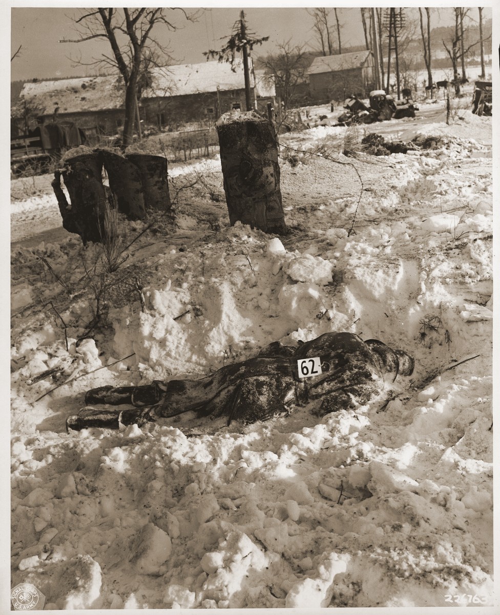 The corpse of an American soldier killed by the SS in the Malmedy atrocity.

The original caption reads "American soldiers were shot by German troops after they had surrendered were left where they had fallen in the snow.  Barbed wire is conspicuous where this soldier had fallen.  These German atrocities were committed on or about the 17th of December 1944 in the vicinity of Five Ponts near Malmedy, Belgium."
