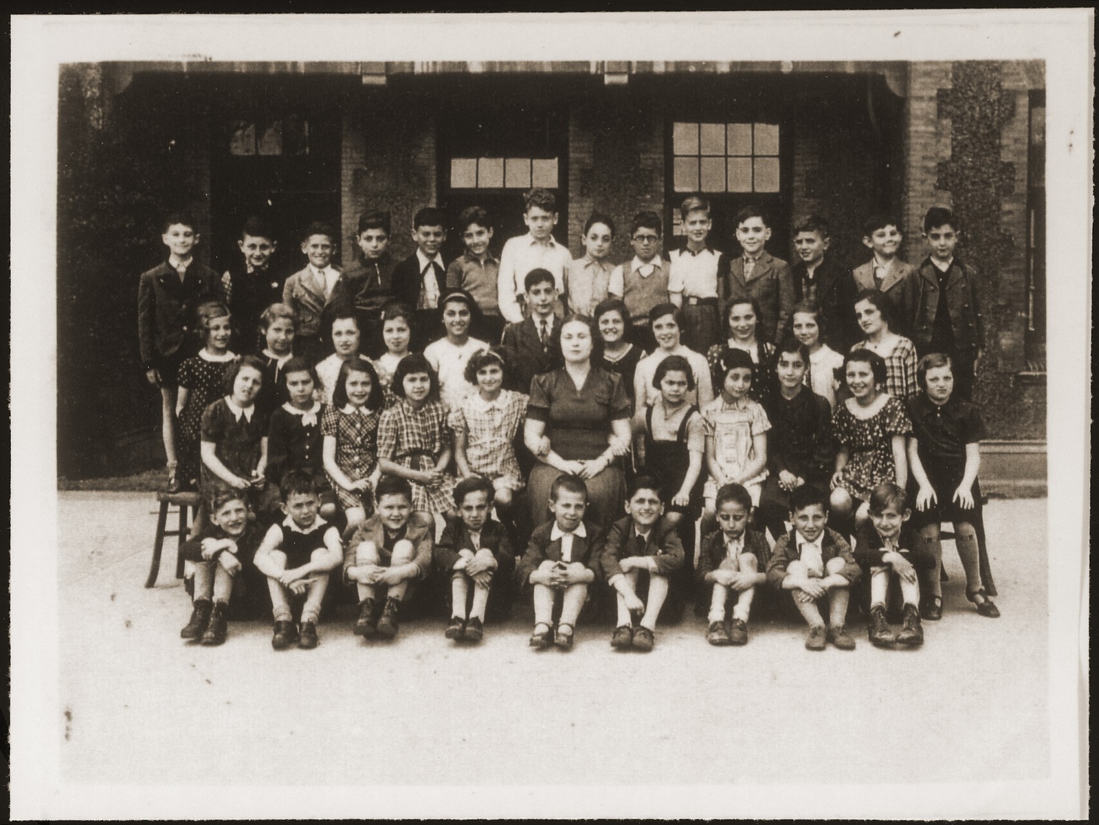 A school class of Jewish refugee children, including Hannelore Mansbacher (seated 2nd row, on the end at far right), at Transition Upper school on Kinchow Road in Shanghai.