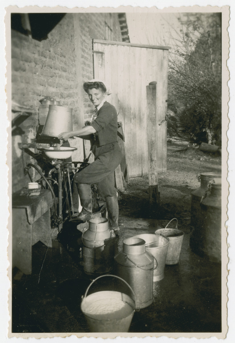 Photograph from an album entitled, "Hacshara Kidma Chile,"  documenting life on a postwar Shomer Hatzair Zionist agricultural collective in Chile.

A young woman empties a bucket of fresh milk into a cream separator (?).   The inscription on the album page (in Spanish) reads, "Aaron's invention, number 11753."