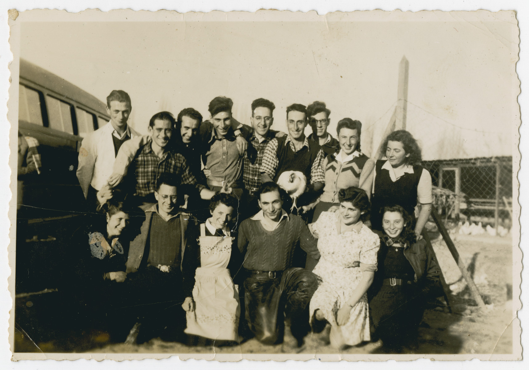 Photograph from an album entitled, "Hacshara Kidma Chile,"  documenting life on a postwar Shomer Hatzair Zionist agricultural collective in Chile.

A group of young adults stops for a photo while traveling by bus to the haschara. The inscription on the back (in German) reads, "Trip to the Hachshara."  The inscription on the album page (in Spanish) reads, "The first Jalutzim [pioneers]...."

Among those pictured are Susi Hirschberg, Hanni Bloch, Finola (?) Muller, Ballo, Carlos Mayer, Manfred Flat, Sallo Asner (?), Hanus Ehrlich (?), Ernst Joel, Ruth Klein, Marion Jokolsh (?), Hans Hoffstatt (?), Ramona Lorn (?), Meck Krotosch, Eva Frankel.