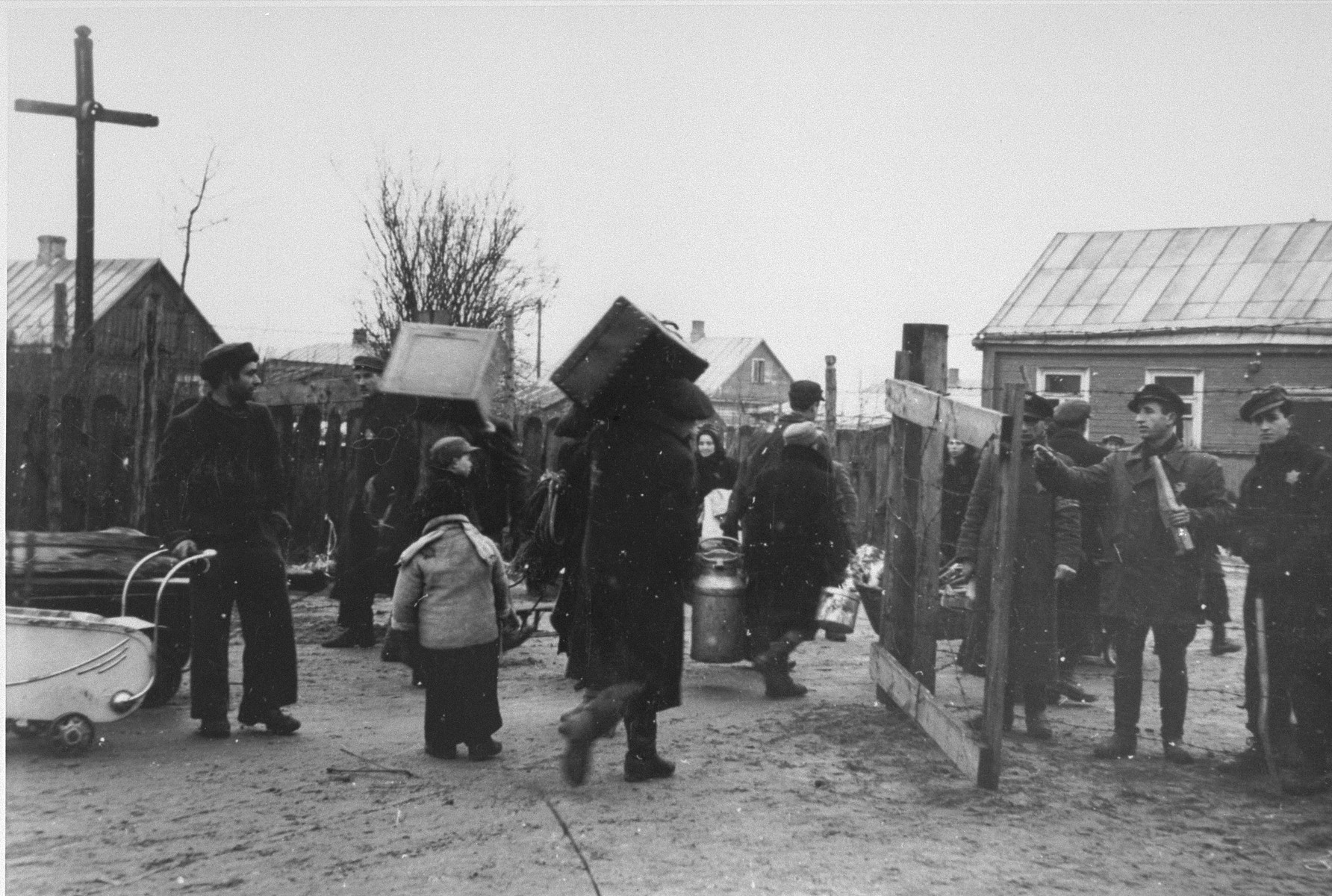 Residents of the ghetto move to new housing, probably after the Germans reduced the size of the Kovno ghetto.

Among those pictured are Abe Malnik (on the right) and Yankel Kaplan (second from the right), a ghetto firefighter.