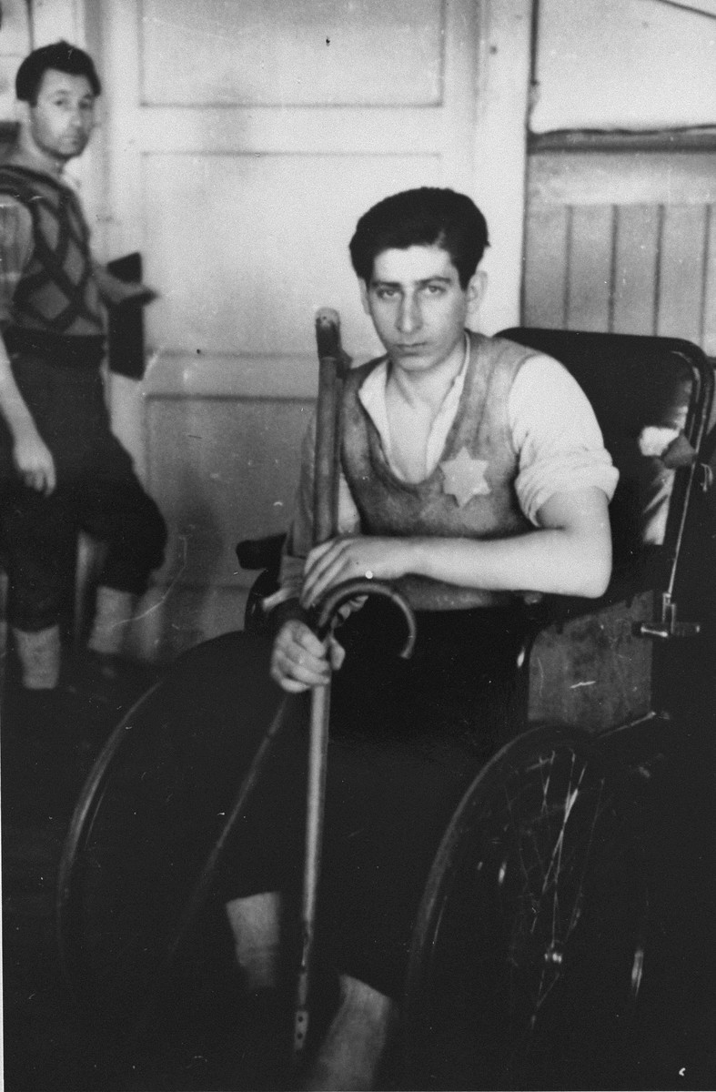 A handicapped youth sitting in a wheelchair.