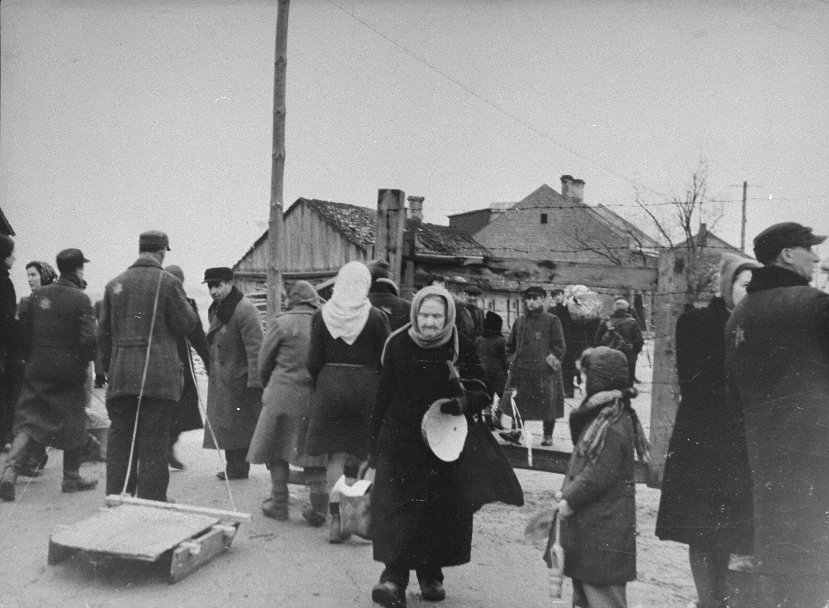 Jews move their household belongings to new quarters in the Kovno ghetto following a reduction in the size of the ghetto.

Among those pictured is Yitzhak Elhanan Rabinowich (far right), Jewish manager of the German labor office in the ghetto.  The elderly woman in the center is Sara Abramowitz.