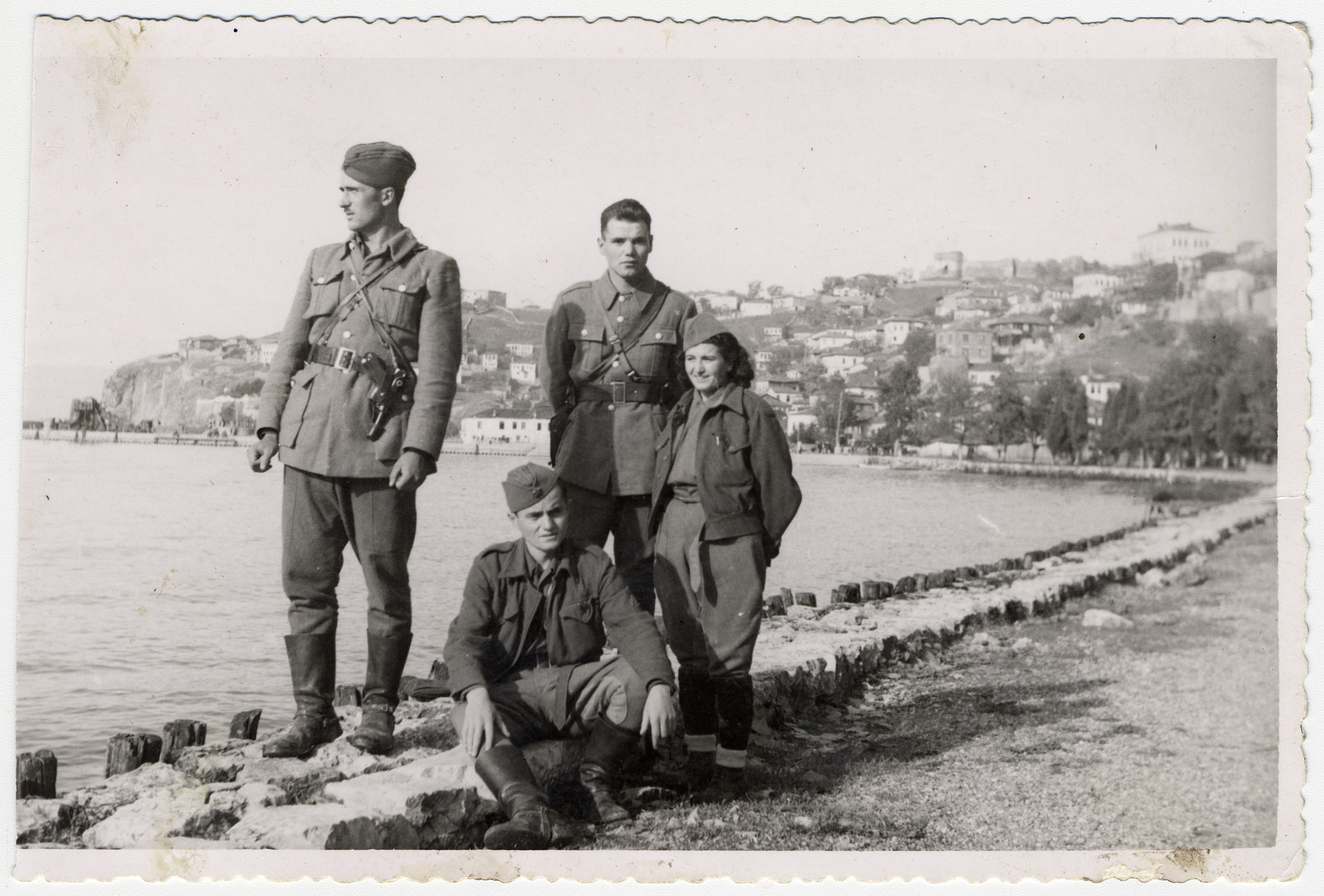 Four resistance fighters on the banks of the Lake Ohrid, shortly after the town's liberation.

Among those pictured are (left to right) unidentified officers (standing and seated), Chede Filipovski, and Commissar Jamila Kolonomos.