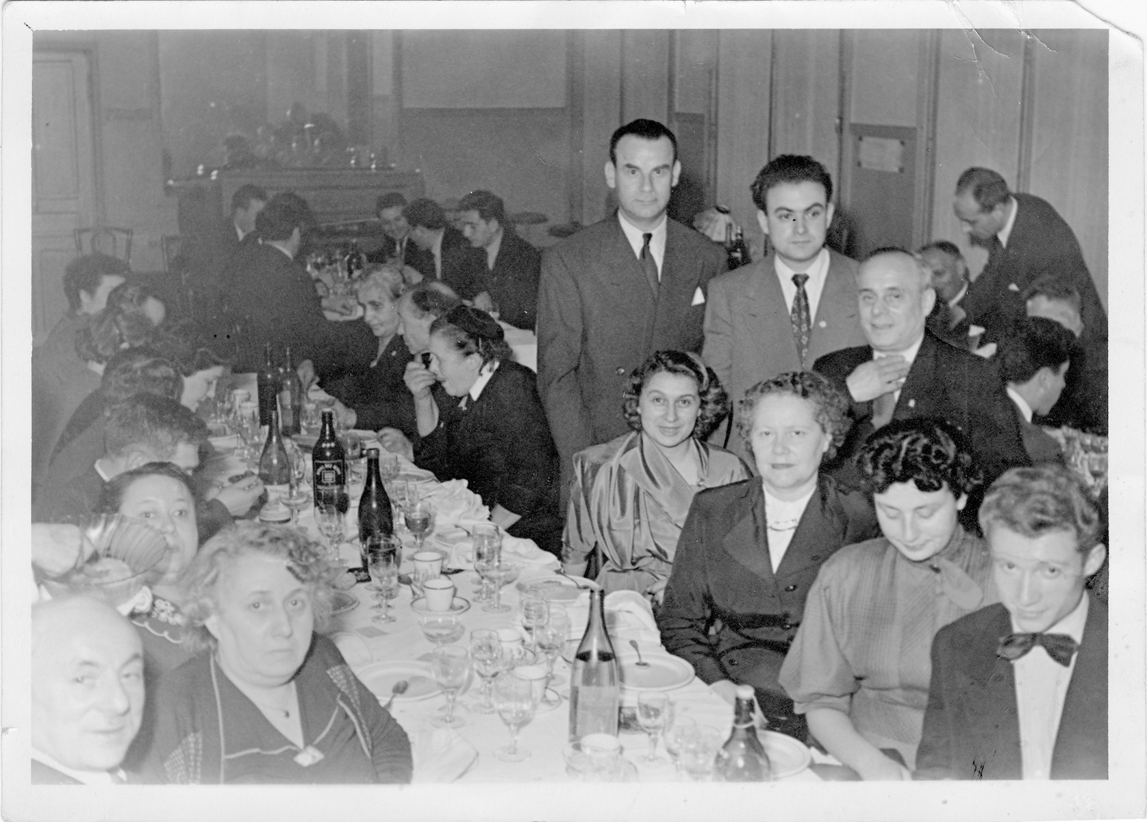 A large extended Jewish family in France celebrates a wedding anniversary.

Faige Tuba Perelstein is seated on the left.  Seated on the right are (back to front) Eva Pelc, Mrs. Victor Perelstein, Lilly Perelstein Jedab, her husban Mr. Jedwab.  Standing behind them (back to front) are Jules Pelc, Rene Perelstein and Victor Perelstein.