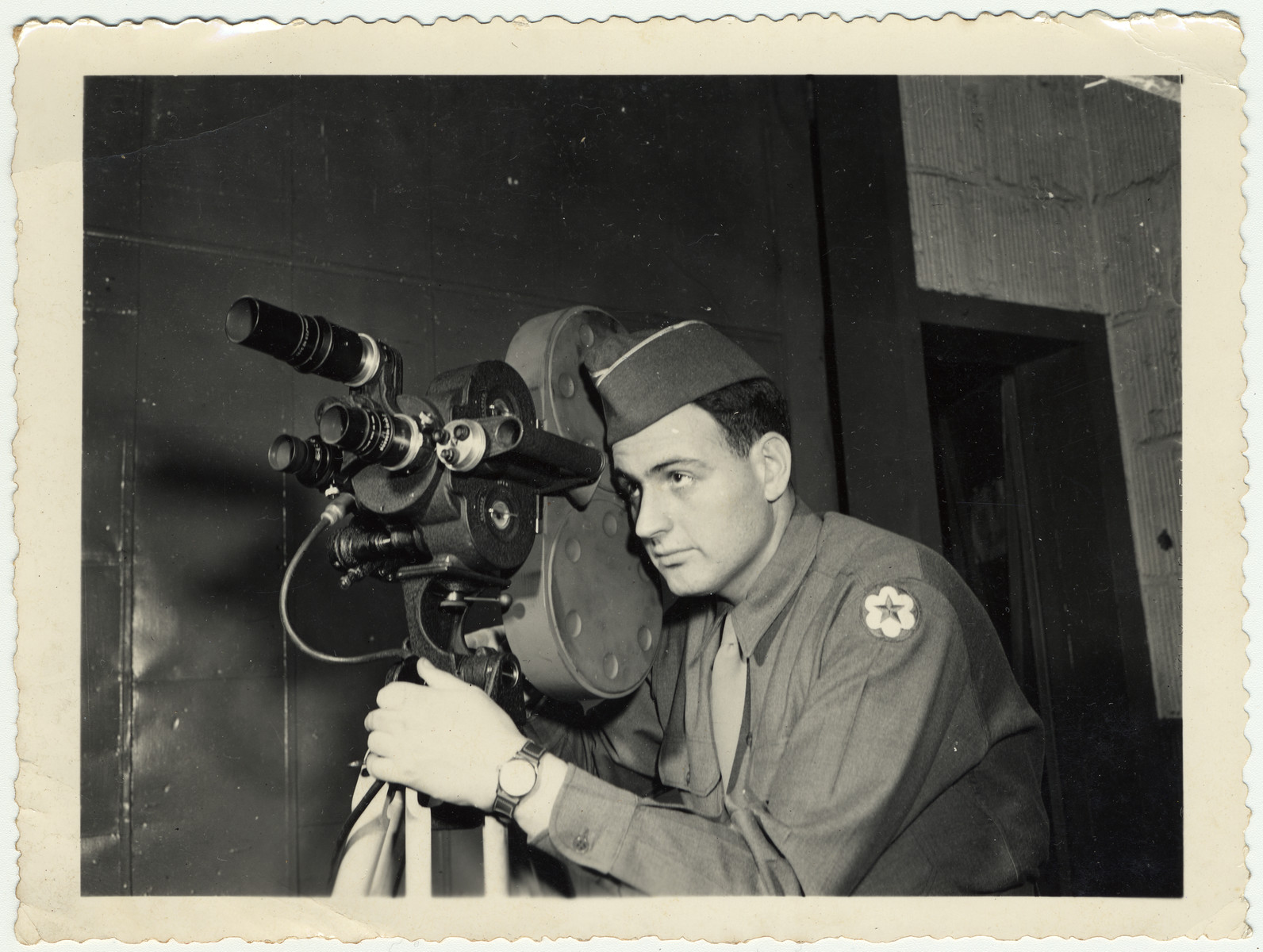 Portrait of American Jewish signal corps photographer Kurt Enfield with his movie camera.