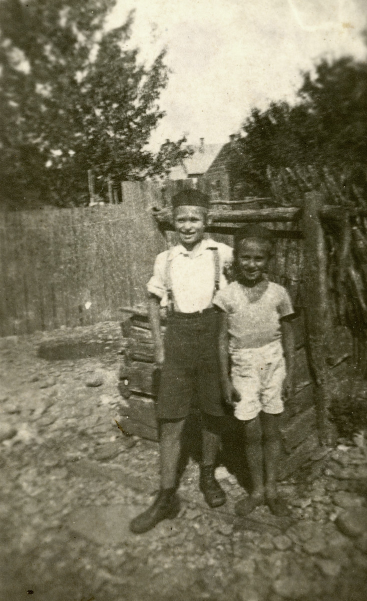 David and Bezalel (Zal) Schaechter stand in front of a well in the yard at their house.