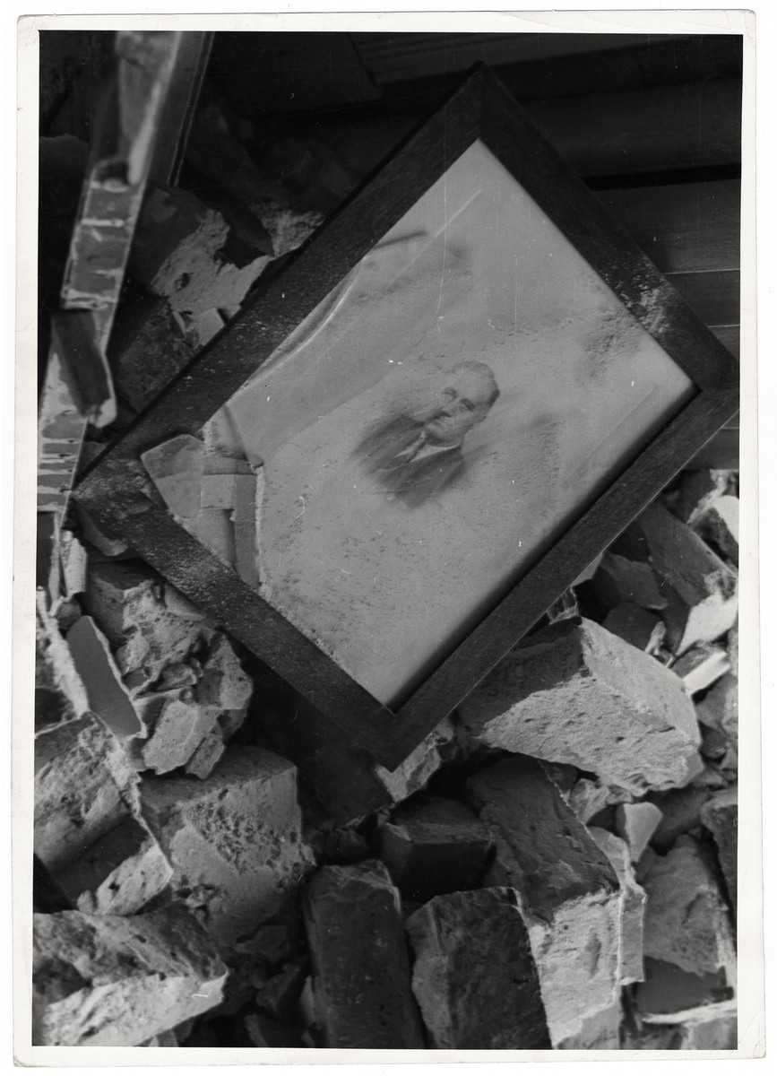 An intact portrait of President Roosevelt  lies amidst the rubble of the destroyed officer of the American Consulate General in Warsaw.