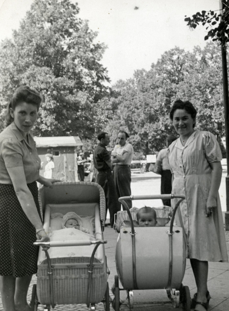 Rywka Markowicz (left) and Ruth Spiler Cymet push their babies in carriages in the Tempelhof displaced persons camp.

Ruth's baby is Lila Sara Cymet.