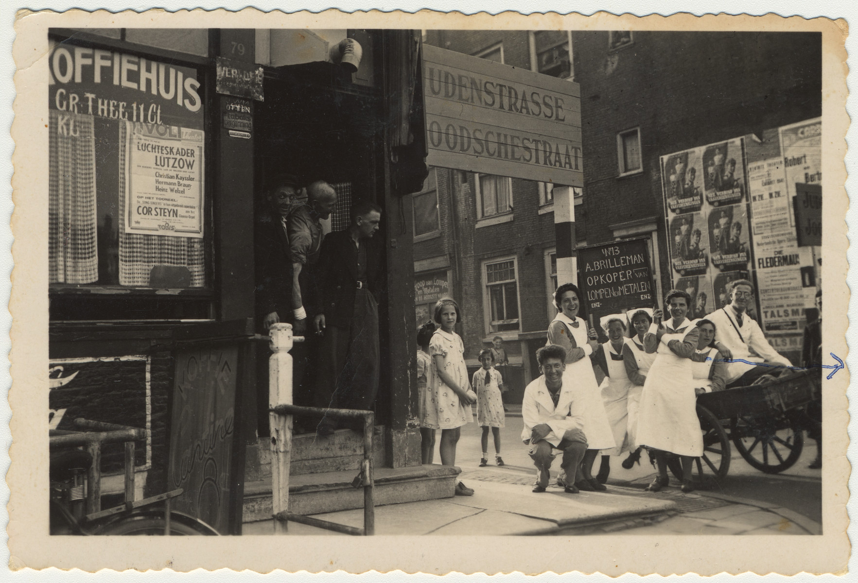 Jewish nurses and nursing students gather around a cart outside a coffee house on Judenstrasse.

Among those pictured is Edith van Dam.