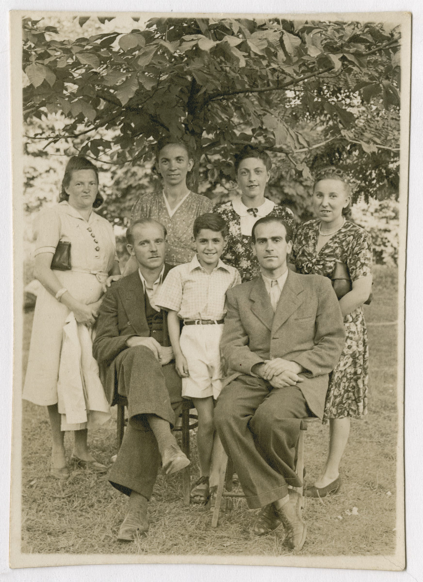 Marian Kwasniewski poses with his parents and rescuers after Lwow's liberation.

Marian (standing center), Josef (seated right) and Helena Kwasniewski (standing second from right) pose with their rescuers Janina Mikolajewicz (far left) and Gienia (far right).