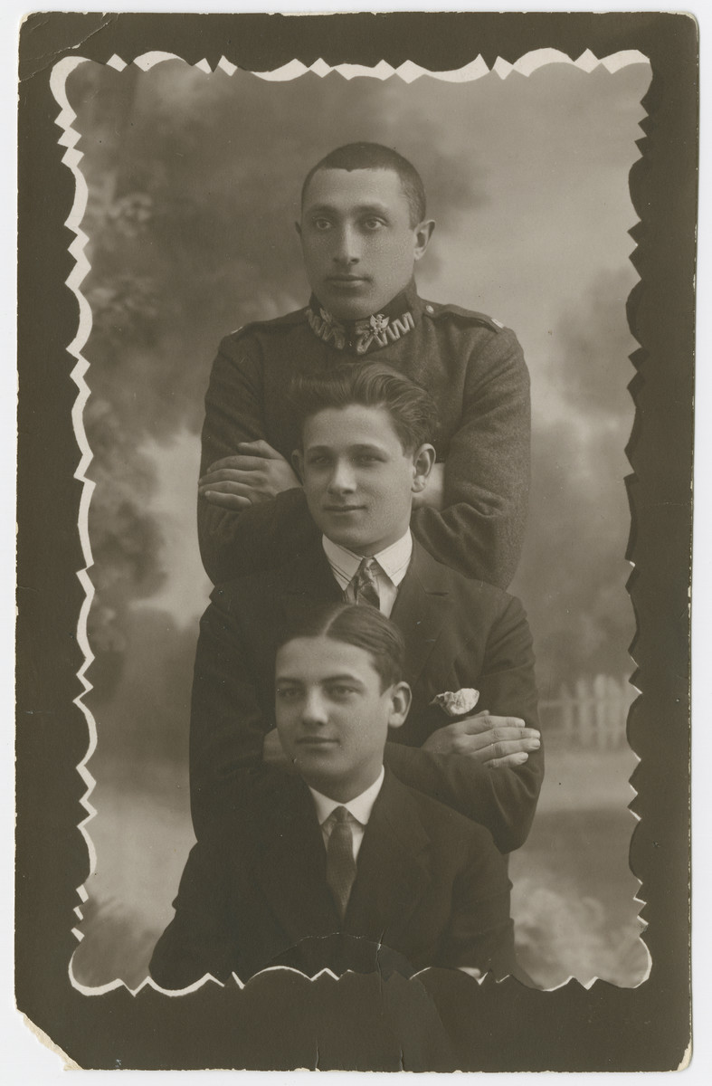 Studio portrait of three Polish Jewish youth in Nowogrodek.

Yehuda Bielski is pictured in the center.