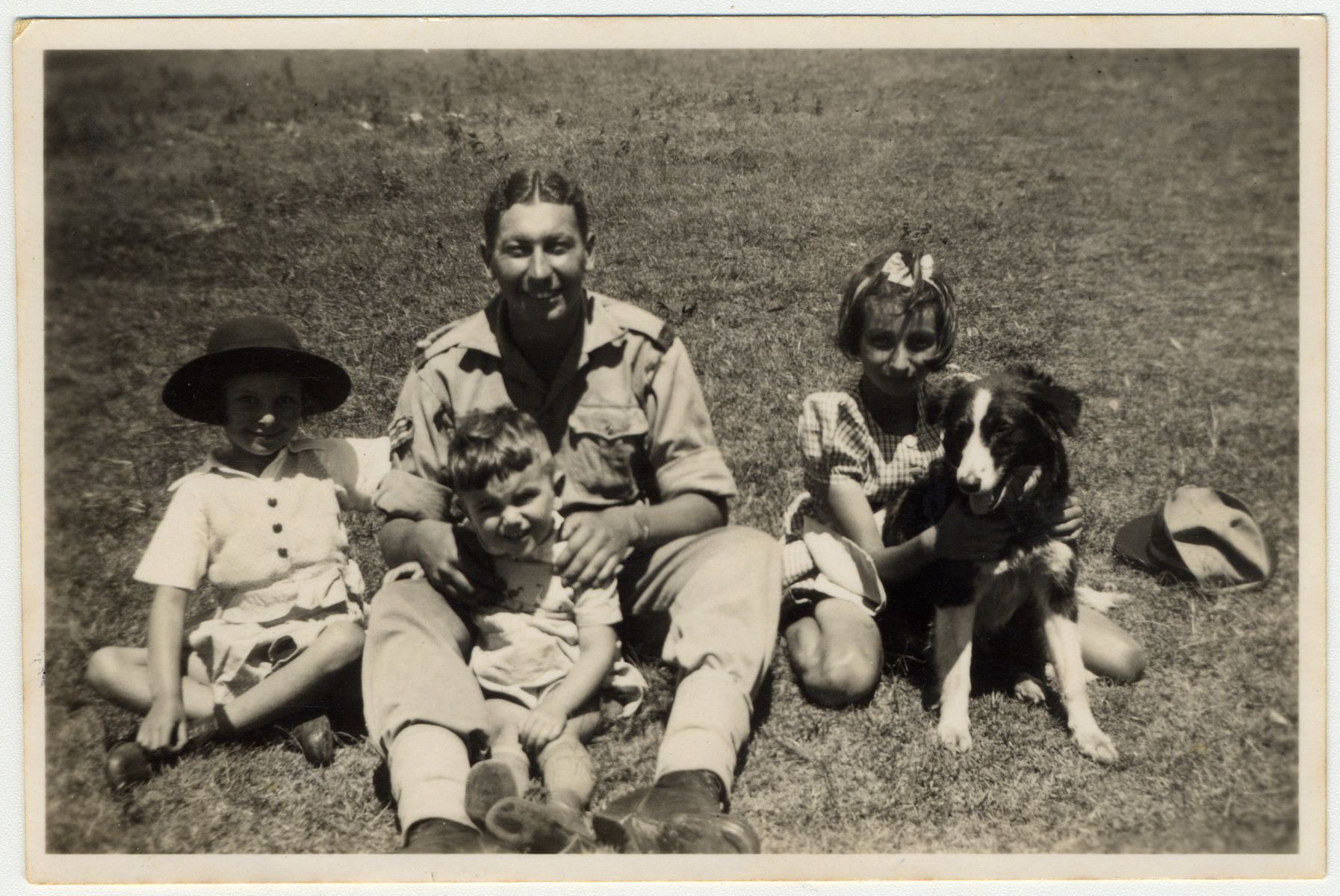 A Jewish soldier in the British army poses with refugee children from Germany on their farm in Kenya where he had come to celebrate Jewish holidays.

Gisela Berg is on the far left and her sister Inge is on the right.  In the center is a Jewish British soldier and Egon Berg.
