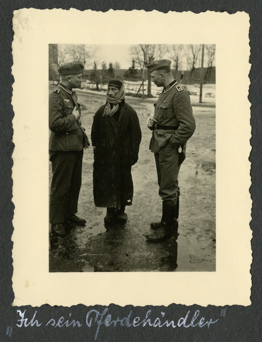 Two German soldiers interrogate a bearded Polish Jew.

The original caption [quotation marks in original] reads: "I am a horse-trader."