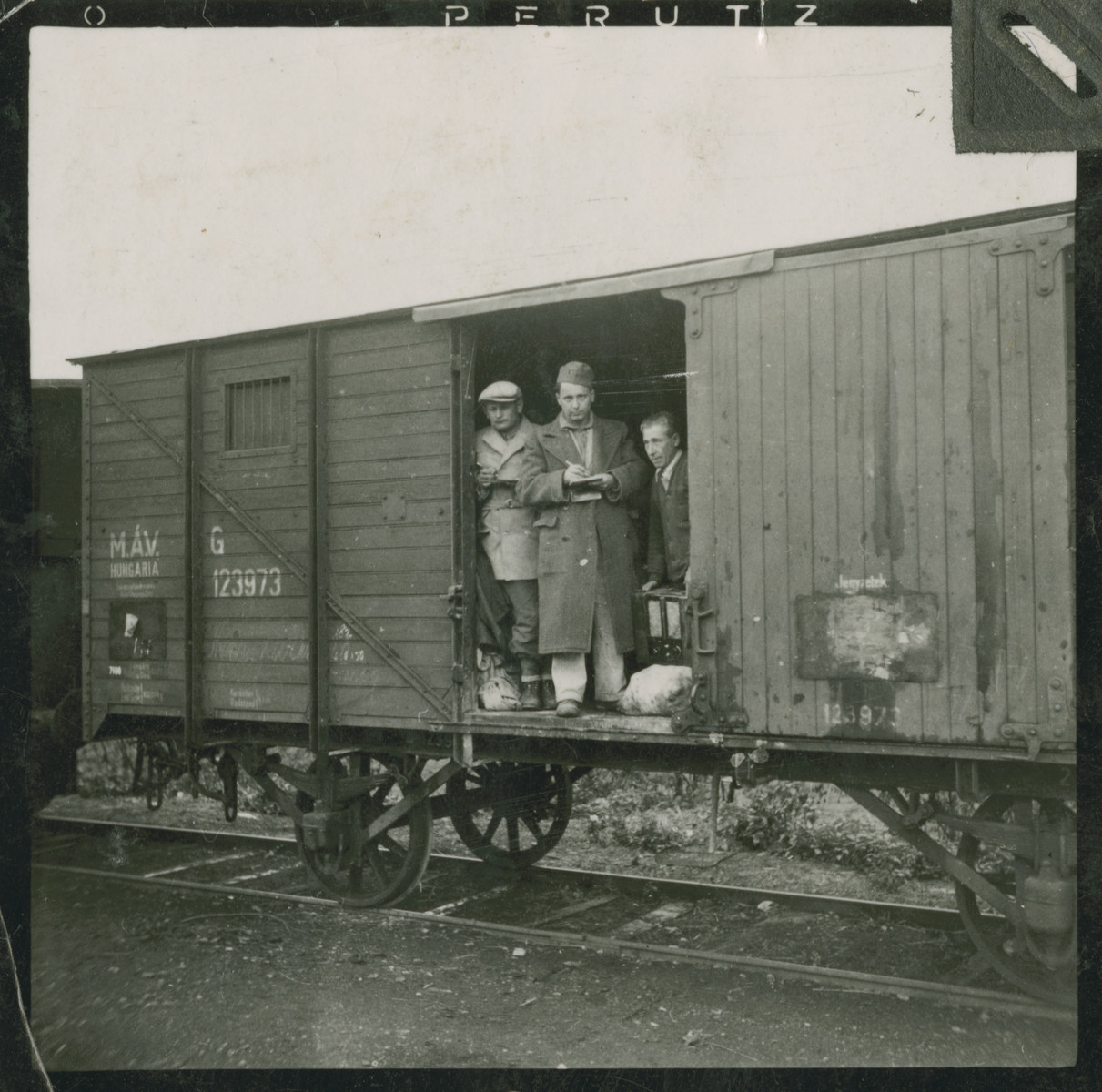 Hungarian Jews stand by the open door of a cattle car while awaiting deportation to a forced labor battalion.

Among those pictured is Imre Winkler.