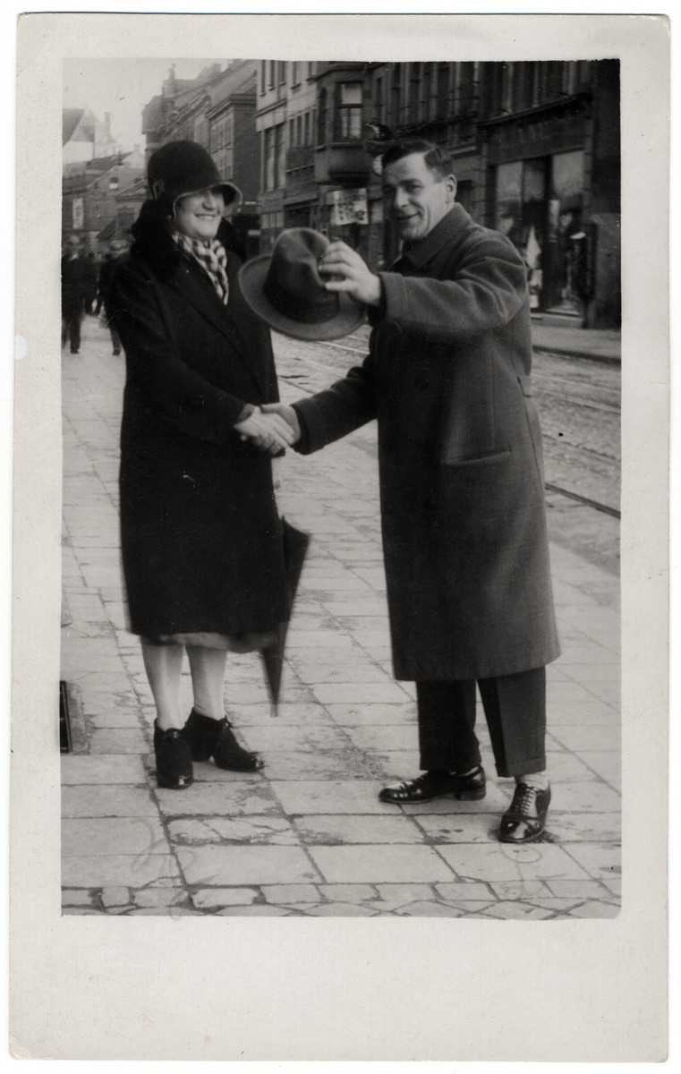 Nesie Bleiweis shakes hands with a friend on a street in Gladbelk, Germany.