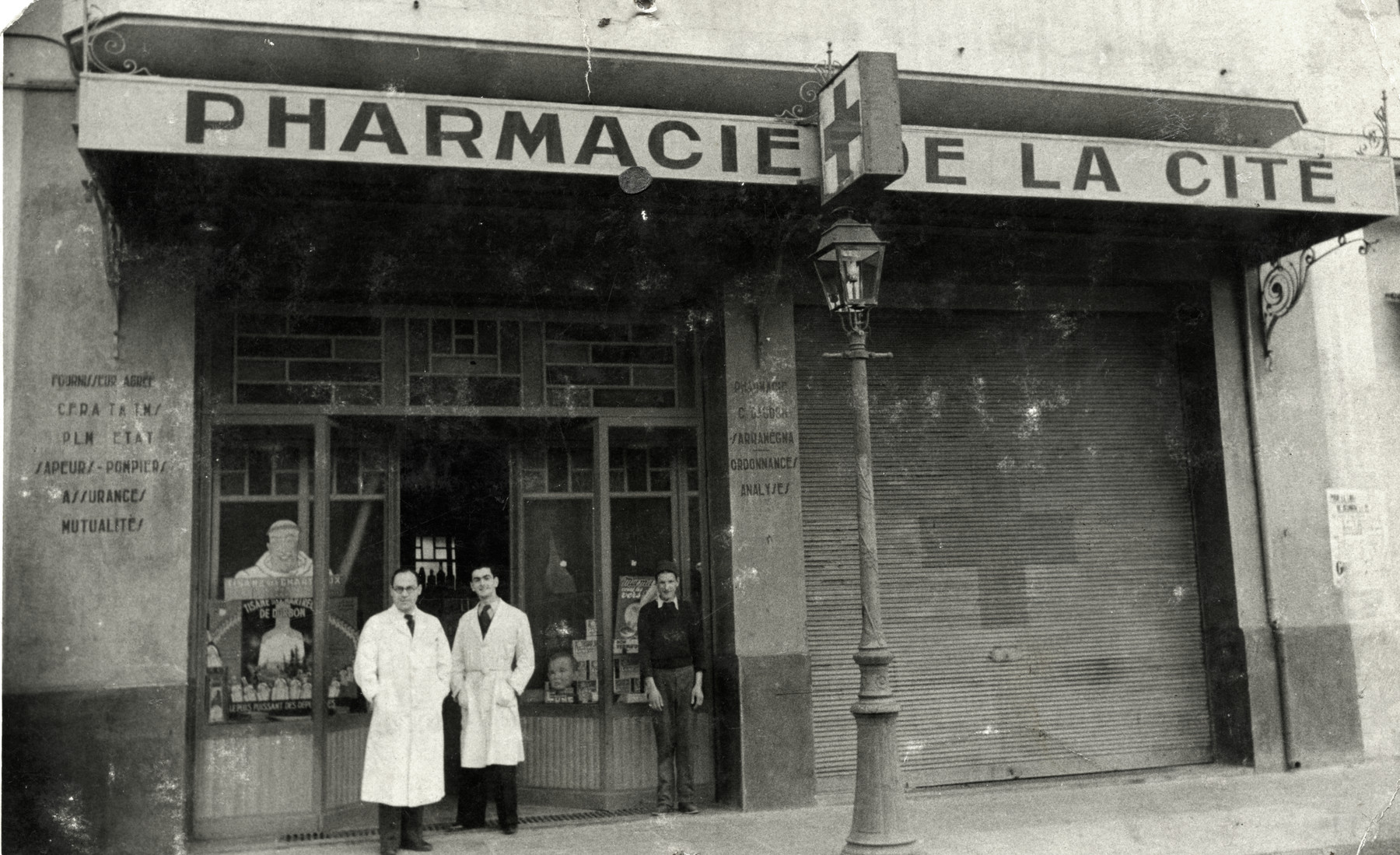 Josef Roger Cheraki stands in front of his pharmacy in Algiers.