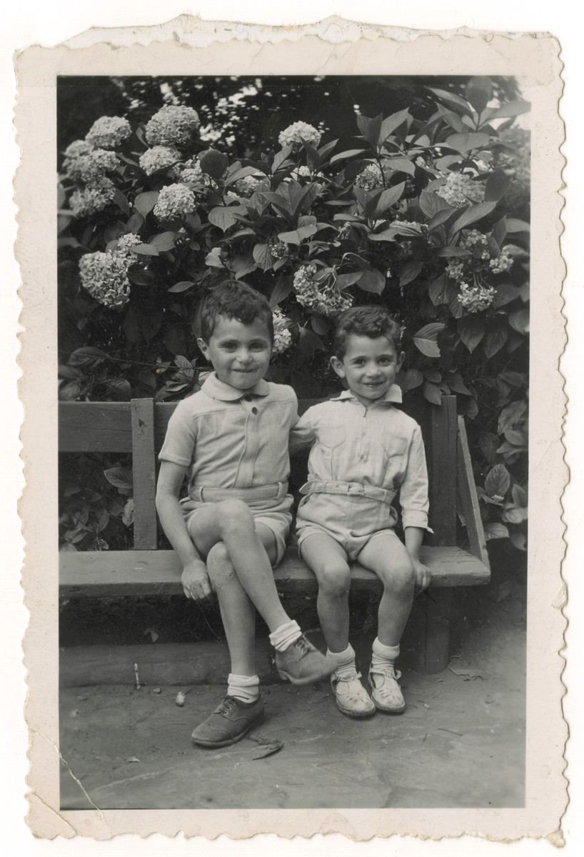 Two Jewish brothers who are living in hiding in German occupied Belgium, sit in the yard of the Mes Enfants children's home in Brussels.

Pictured are Nestor (right) and Jacques Hochglaube (left).