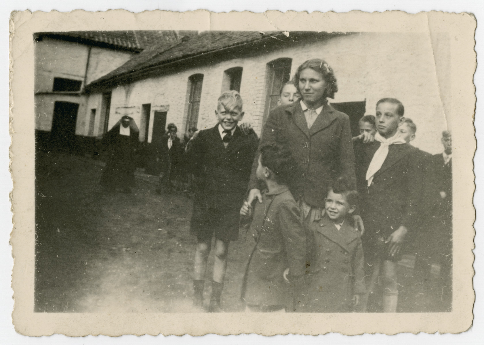 Two Jewish brothers stand in front of the Polish maid who is hiding them in the Belgian countryside.  

Pictured are Nestor (right) and Jacques Hochglaube (left).