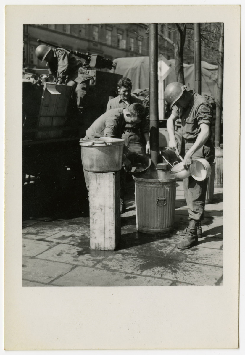 American soldiers scrape out pots on liberation day in Pilsen, Czechosovakia.