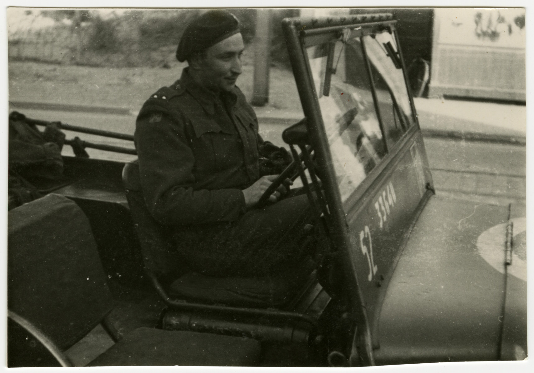 Oscar Lowy, a soldier from the Czech Brigade drives his jeep through Pilsen, Czechoslovakia on its liberation day.