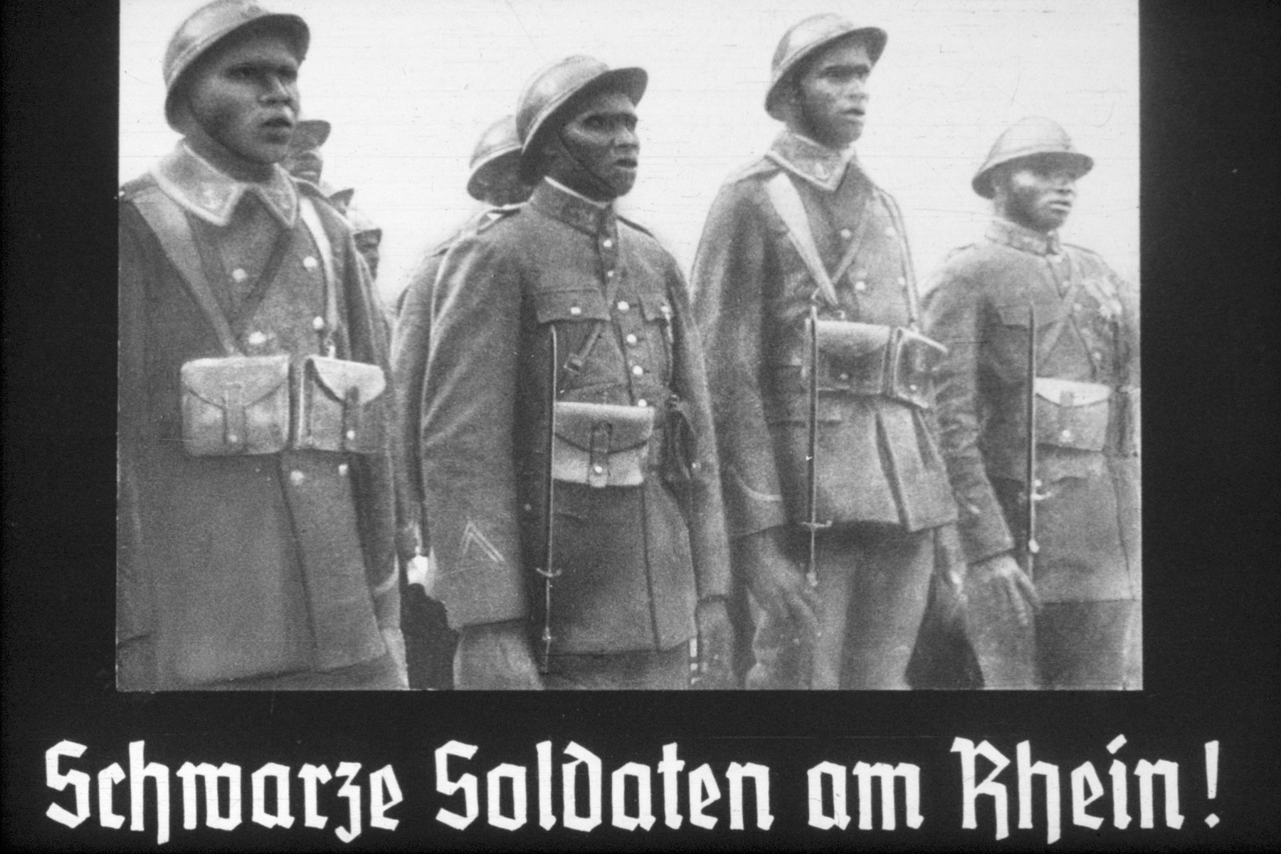 22th slide from a Hitler Youth slideshow about the aftermath of WWI, Versailles, how it was overcome and the rise of Nazism.

Schwarze Soldaten am Rhein!
//
Black soldiers on the Rhine!