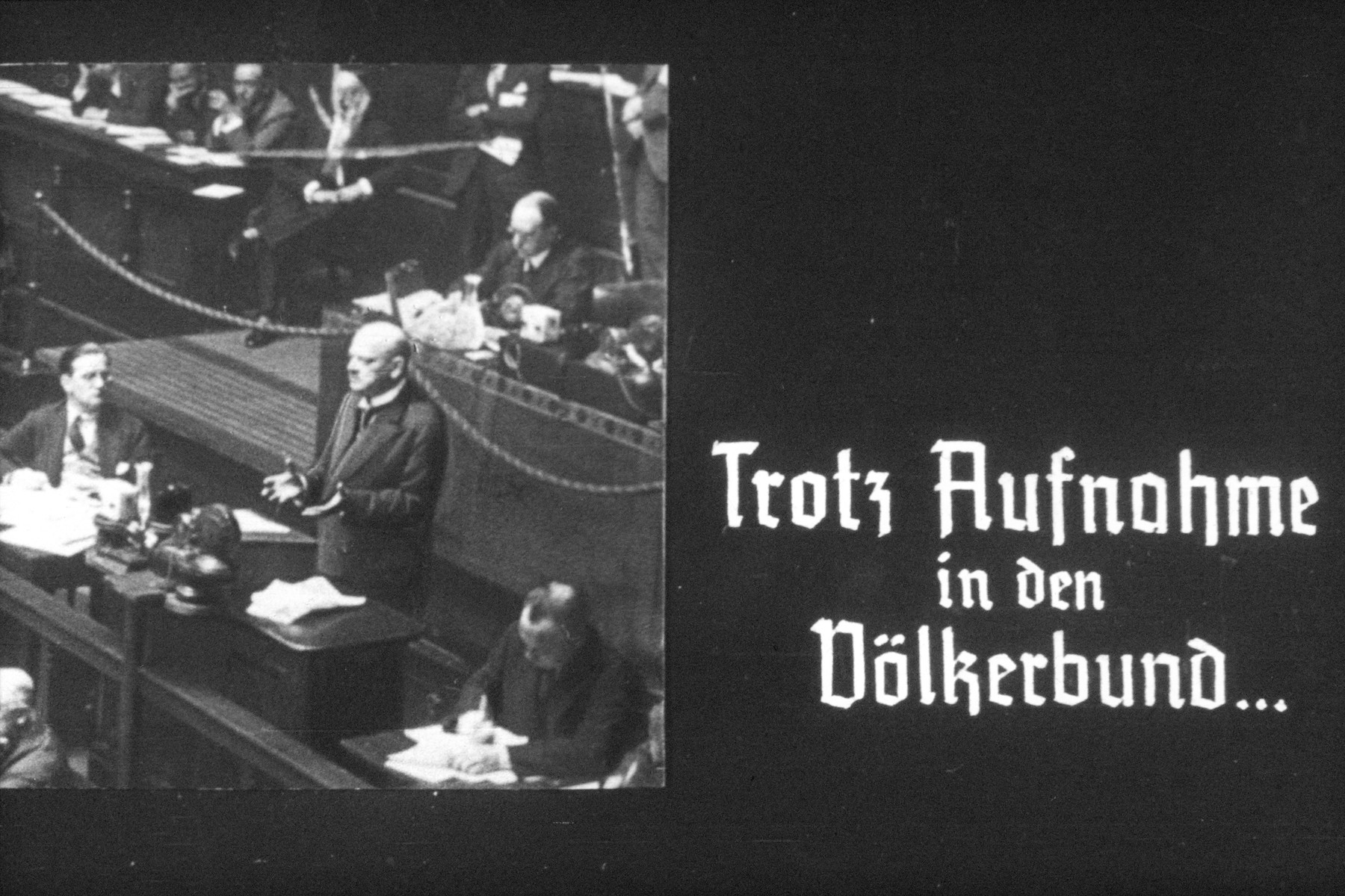 19th slide from a Hitler Youth slideshow about the aftermath of WWI, Versailles, how it was overcome and the rise of Nazism.

Trotz Aufnahme in den Völkerbund...

Despite inclusion in the League of Nations...