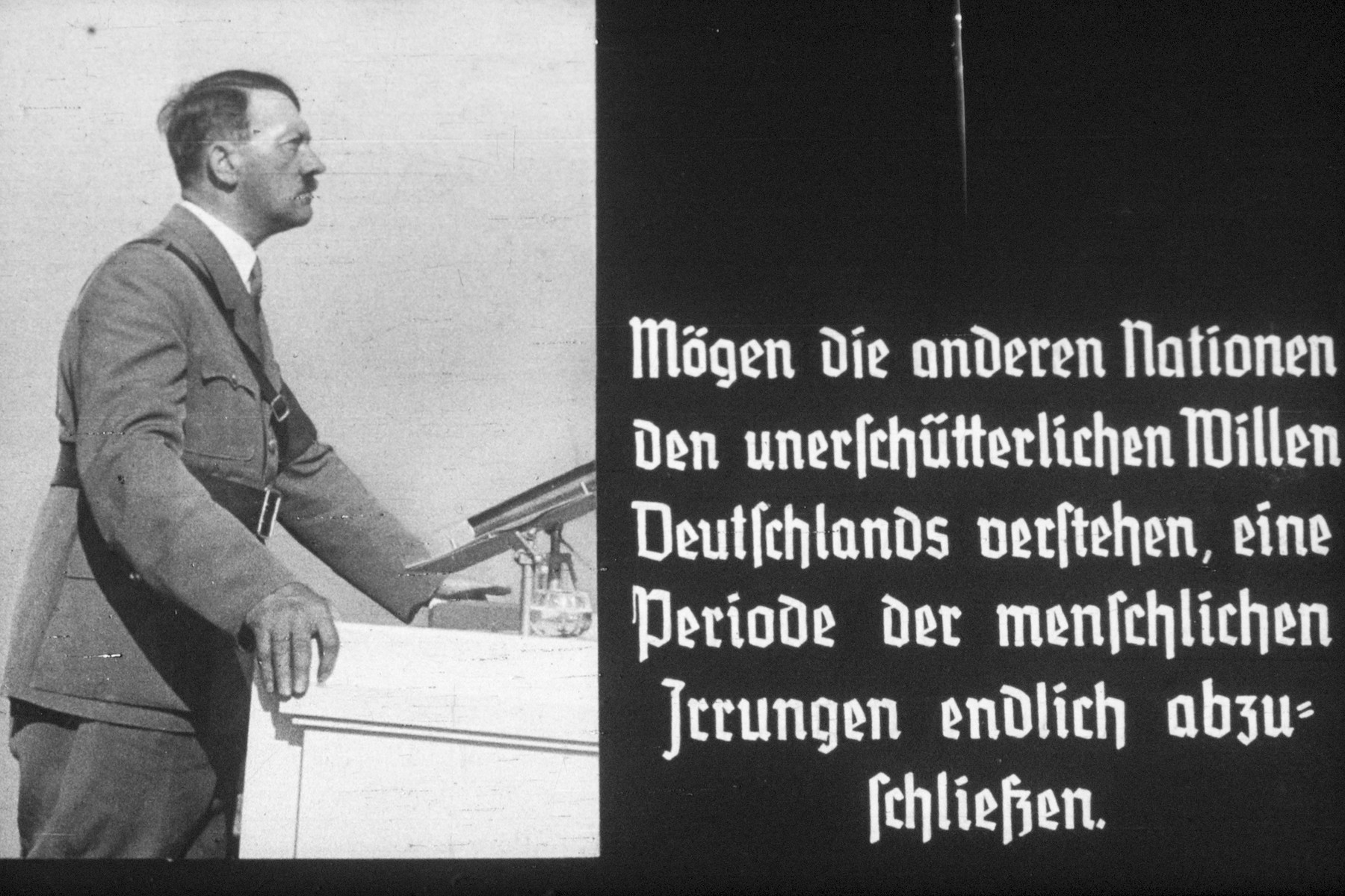 9th slide from a Hitler Youth slideshow about the aftermath of WWI, Versailles, how it was overcome and the rise of Nazism.

Mögen die anderen Nationen den unerschütterlichen Willen Deutschlands verstehen, eine Periode der menschlichen Irrungen endlich abzuschliessen.
//
Let the other nations understand the unshakeable will of Germany to conclude a period of human errors at last.