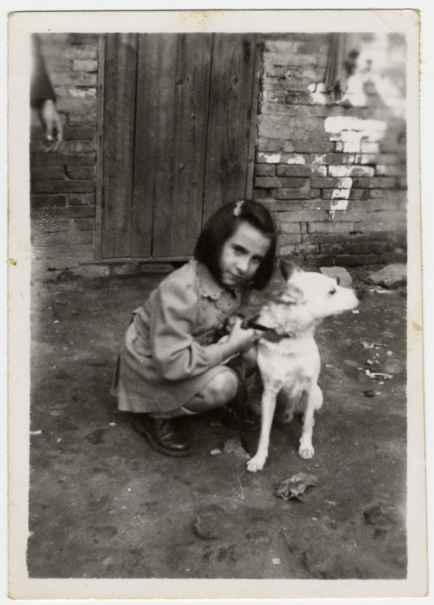 Helga Schneider poses with her dog Bobby on a street in Shanghai.