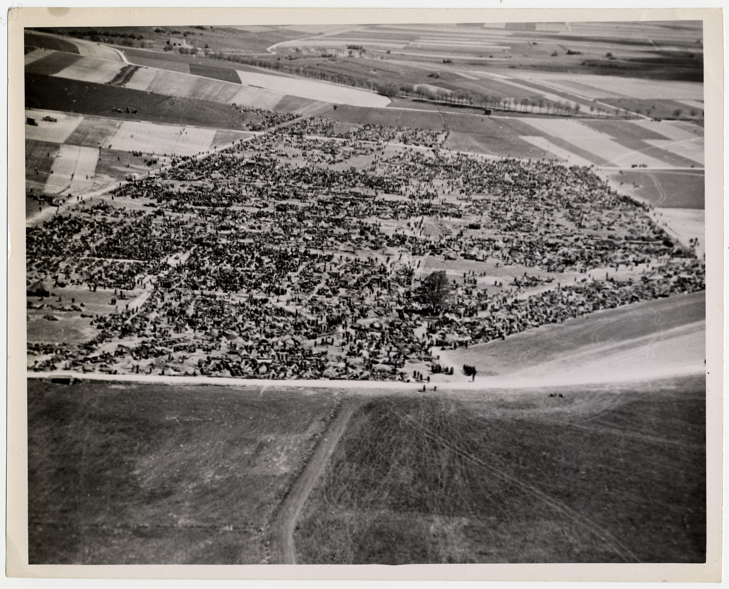 Aerial photograph of an American Army prisoner-of-war camp in Brilon, Germany.

Original caption reads: "The camp, 75 miles northeast of the Rhine River city of Cologne, holds some of the 316,930 Nazi troops captured in the Ruhr pocket by American forces. It was announced April 22 that a total of 2,260,156 prisoners had been taken by the Allies on the Western Front since "D-Day" (June 6, 1944)."

U.S. Signal Corps photo ETO-HQ-45-33419