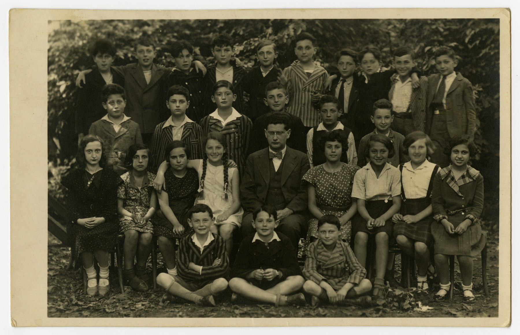 Class portrait of the Juedische Gemeinde Schule in Brno, Czechoslovakia.   

Sali Berl, seated far left, was among the few survivors of her class.