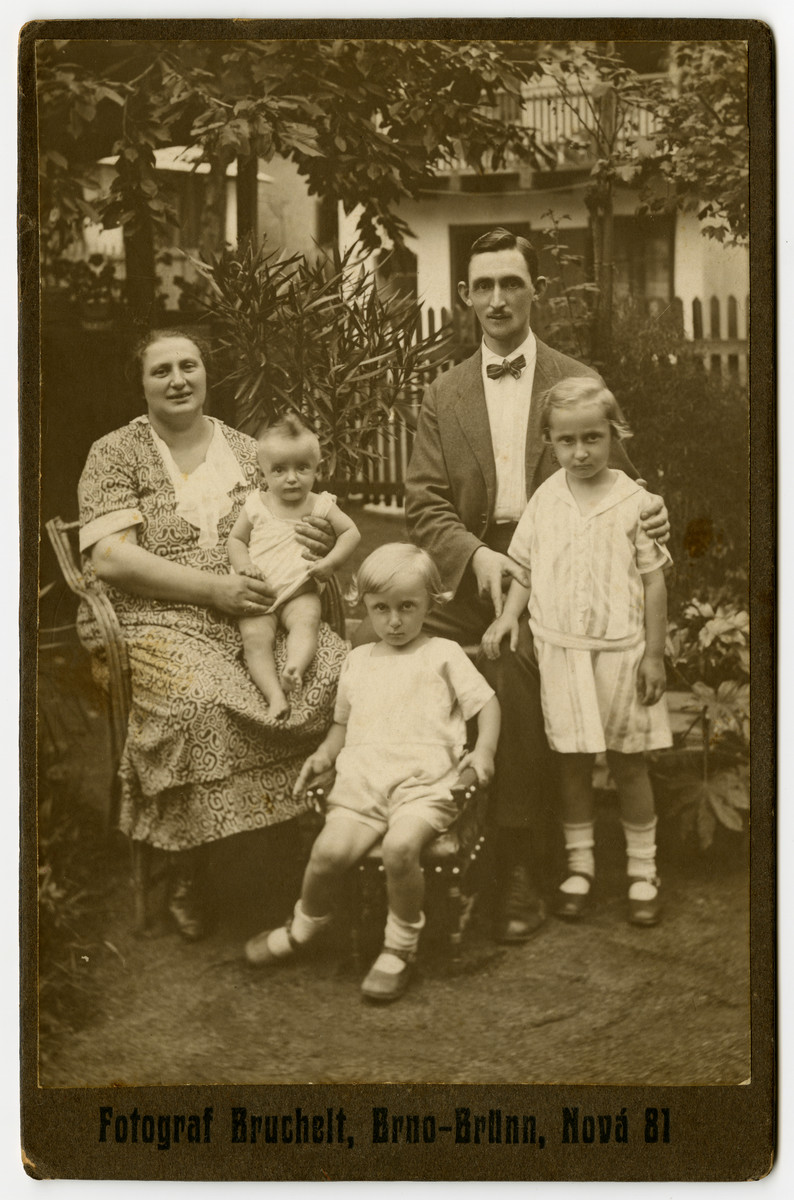 A Czech-Jewish family poses for a portrait in their garden.  

Pictured are Helene and Herman Berl with their children, Sali, Leo, and Malvina.