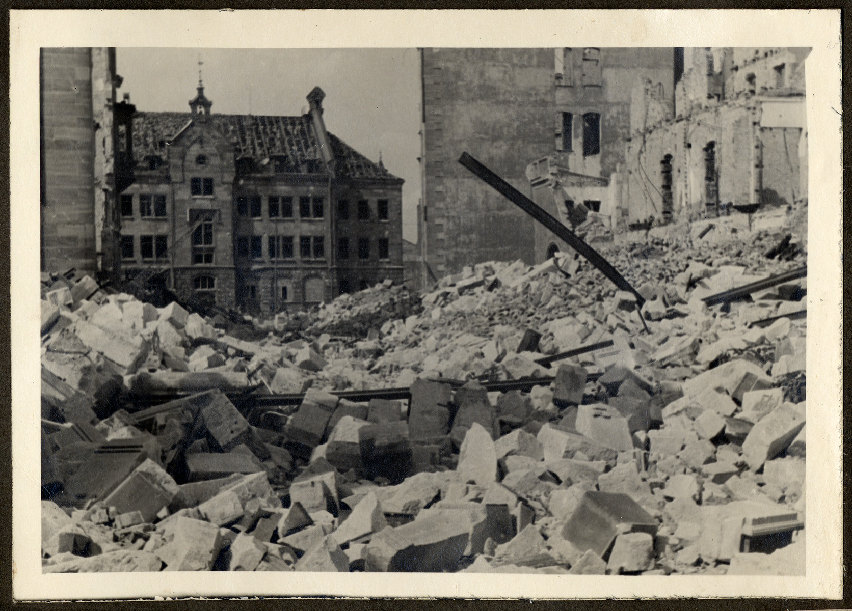 Postwar view of a rubble-strewn bombed out street in Nuremberg.

The original caption reads: "Of the Essenweinstrasse not even the street is left."