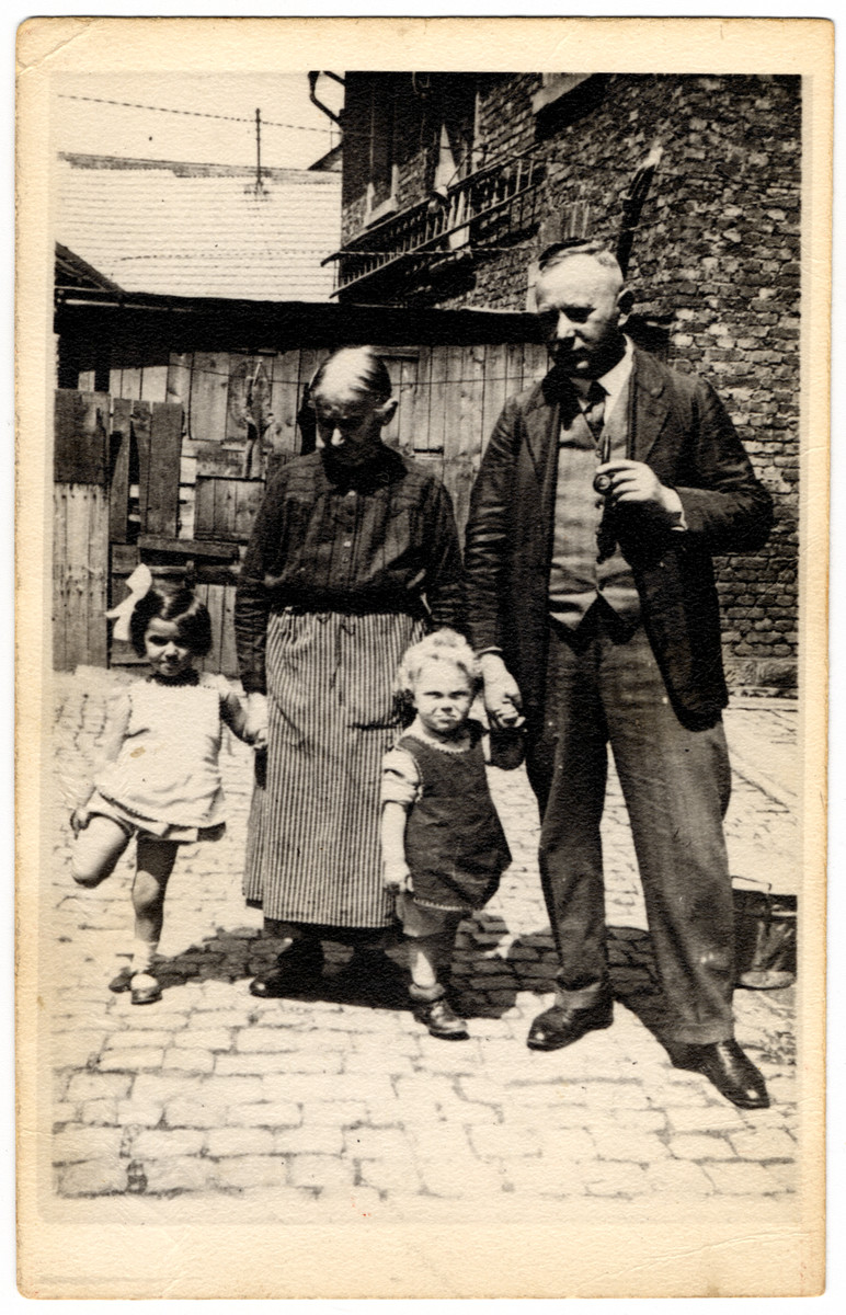 The Moritz family poses in an outdoor courtyard.

Pictured are Liesl (a cousin of the donor), Regina Wendel Moritz  (grandmother of the donor), Alfred Moritz and Ludwig David Moritz.