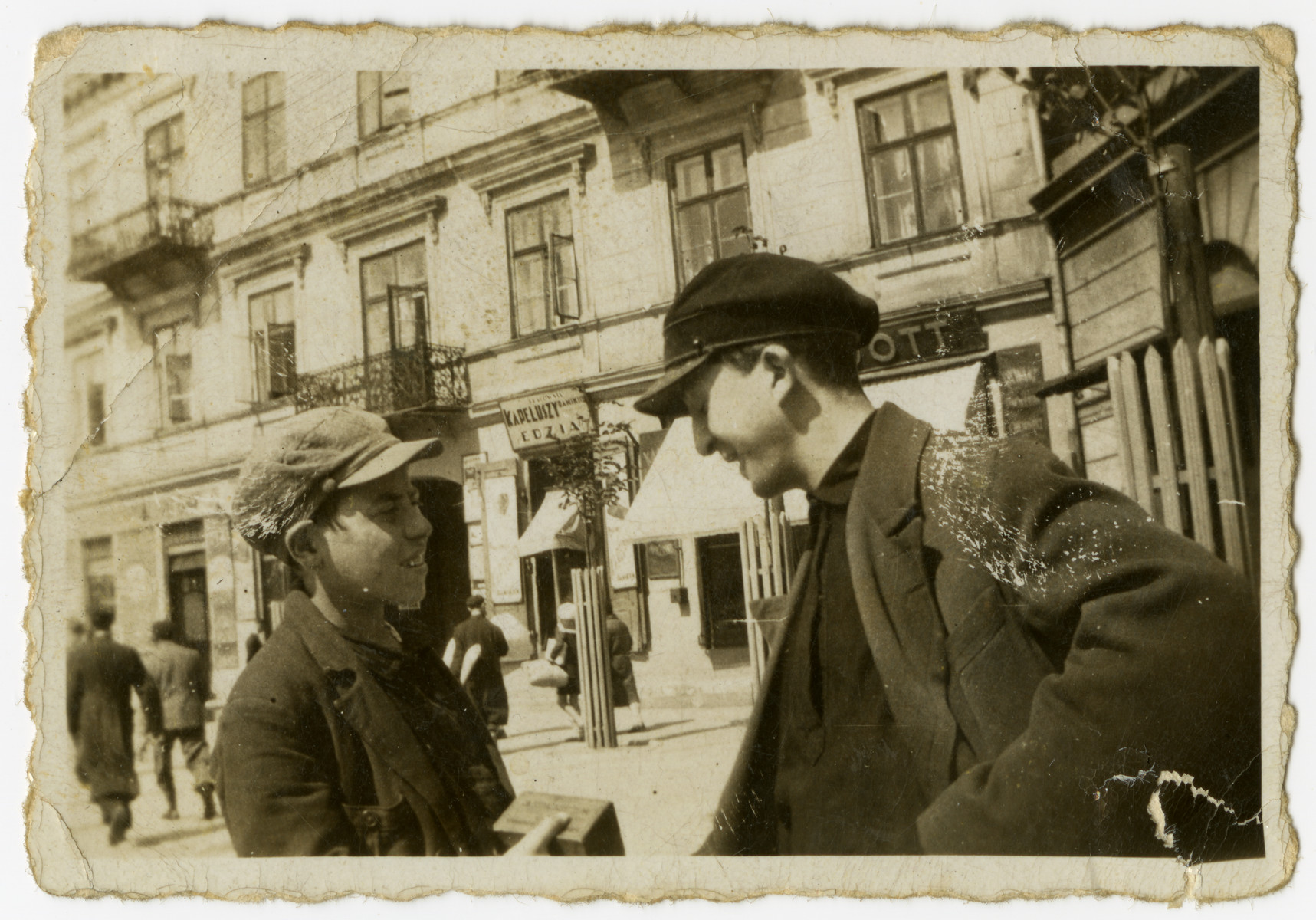 Mendel Grosman (right) talks to a friend on a street in Lodz.