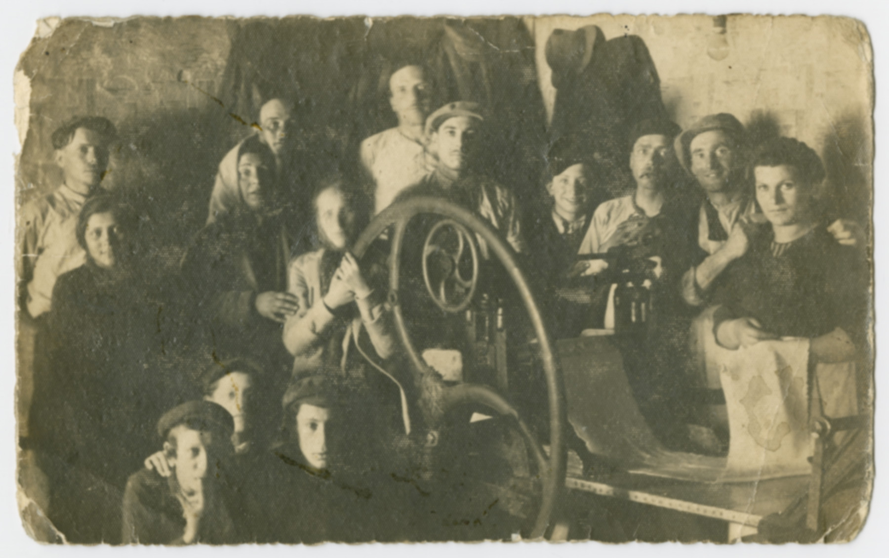 Group portrait of workers in a matzah factory.

Sandor Grunspan (uncle of the donor) is pictured in the center.  He died one week after liberation.